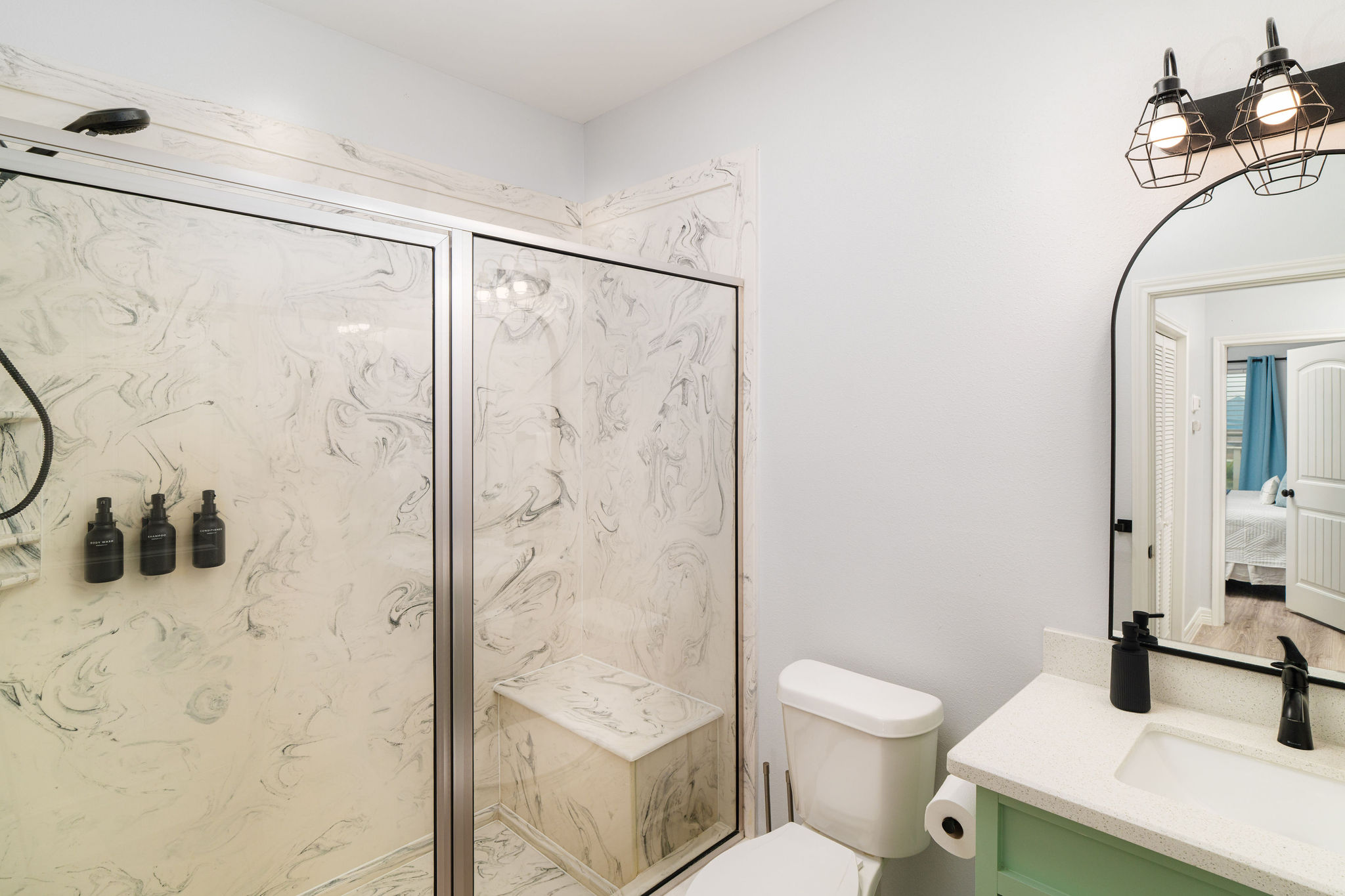 Shared upstairs bath — serves the Wave Room and the Bunk Room. Wide vanity for rushed mornings.