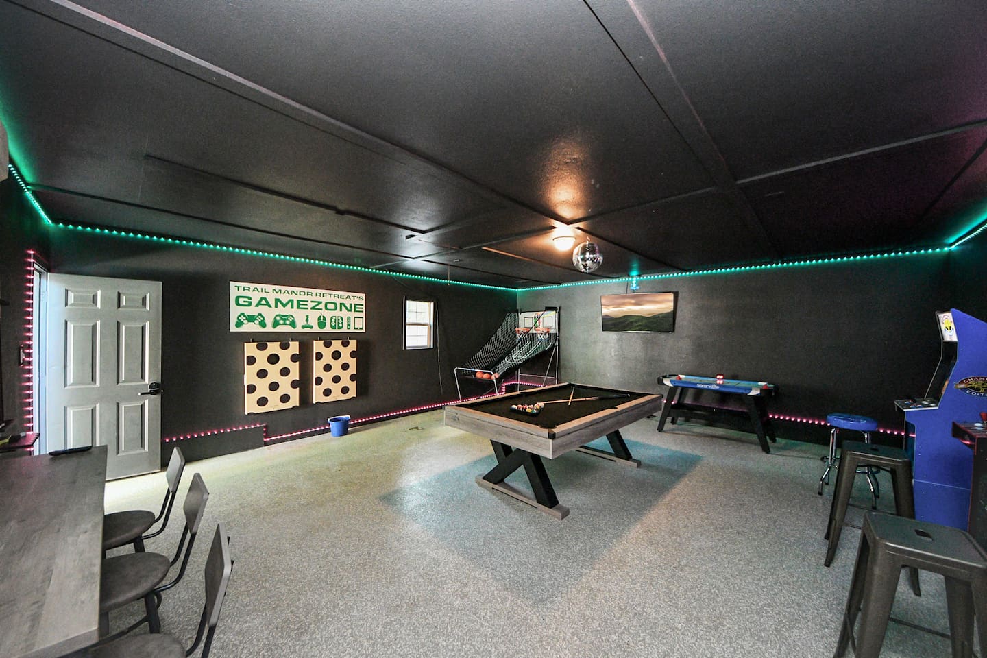 PRIVATE GAME ROOM separate from the house! Another view of this great play space complete with a cornhole set!