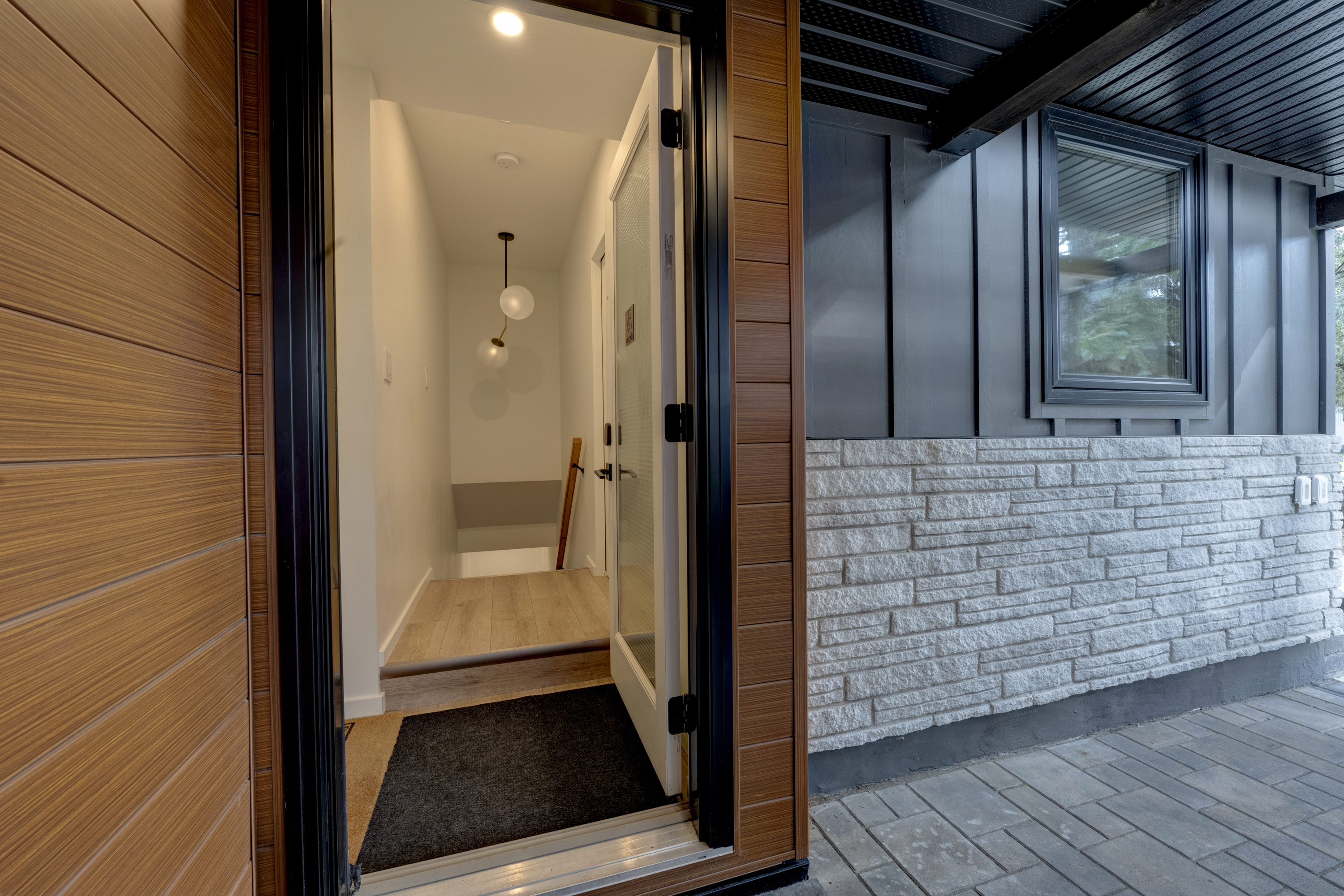 Shared entry and stairway leading to the lower-level guest suites.