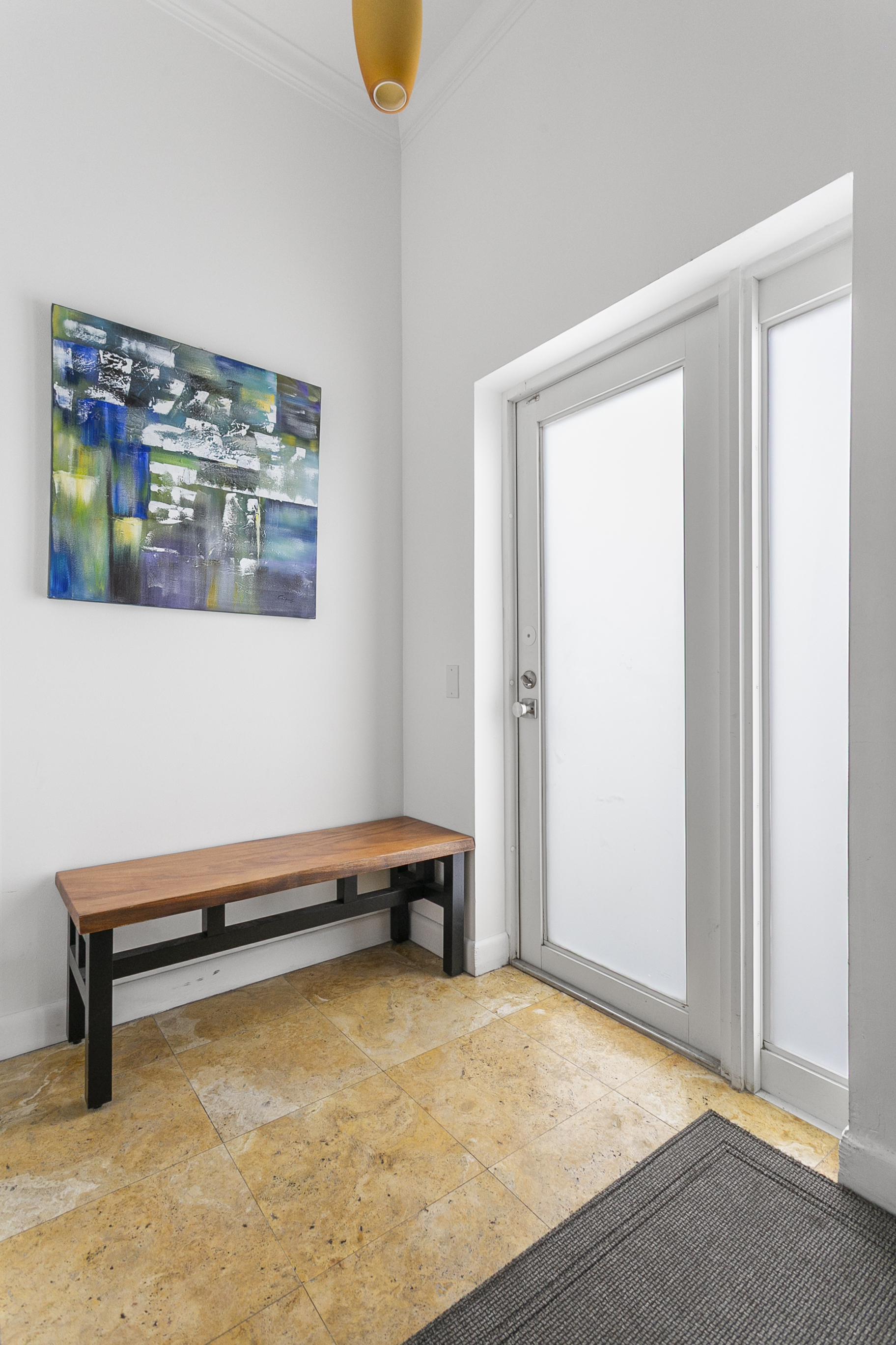 Private entrance foyer with storage space, easily accessible beach gear, and a bench