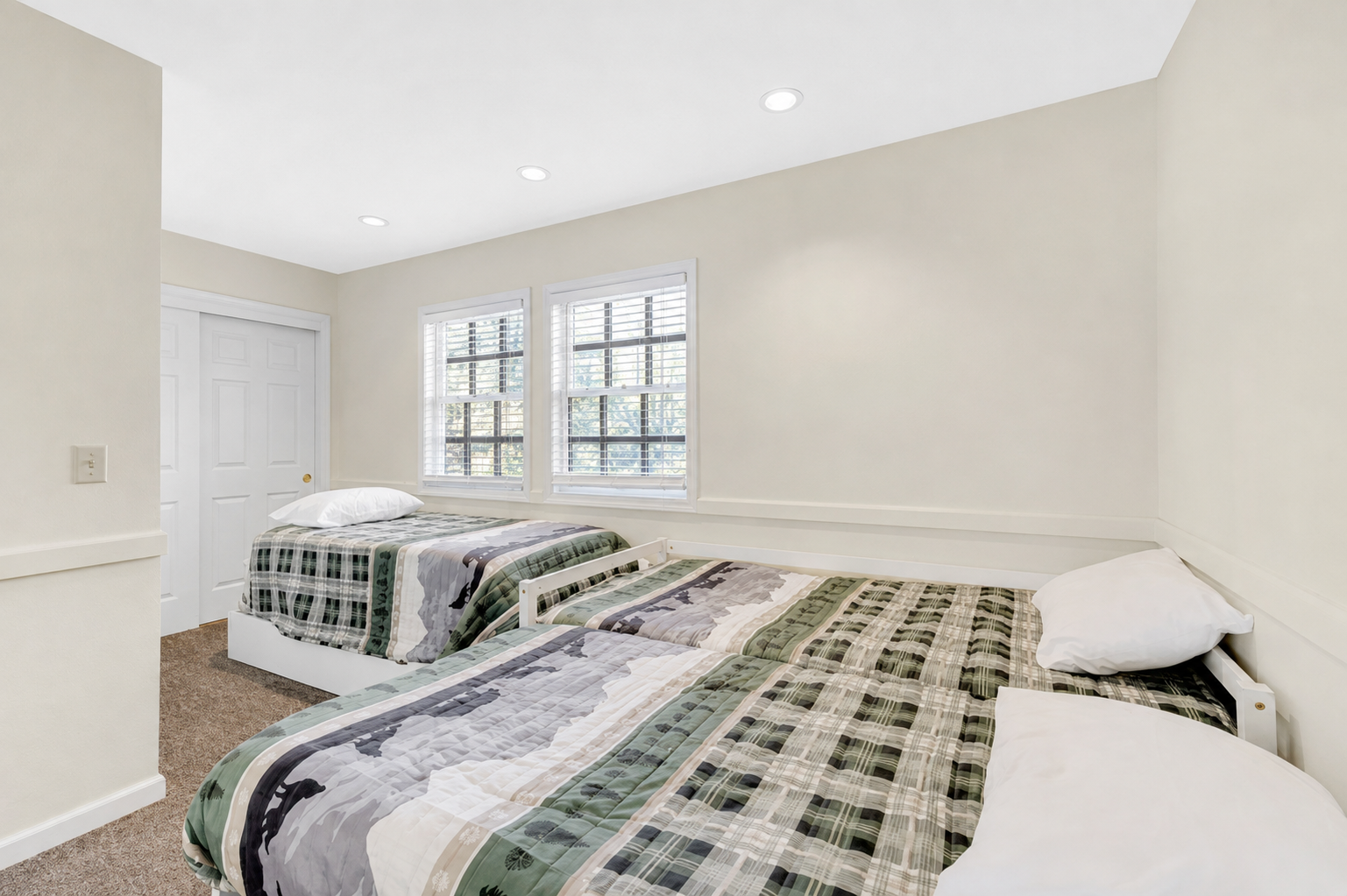 Bedroom 3 with three twin beds and a simple setup for kids, friends, or extra guests.
