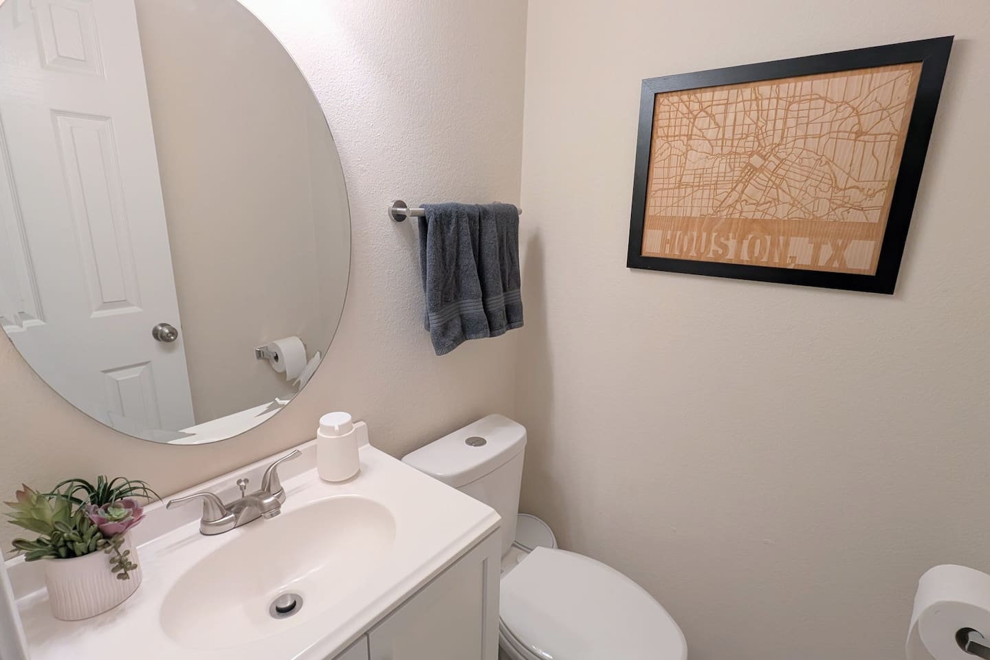 Convenient half bath is located near the downstairs living space and is stocked with foaming hand soap, fluffy towels, and water efficient toilet.