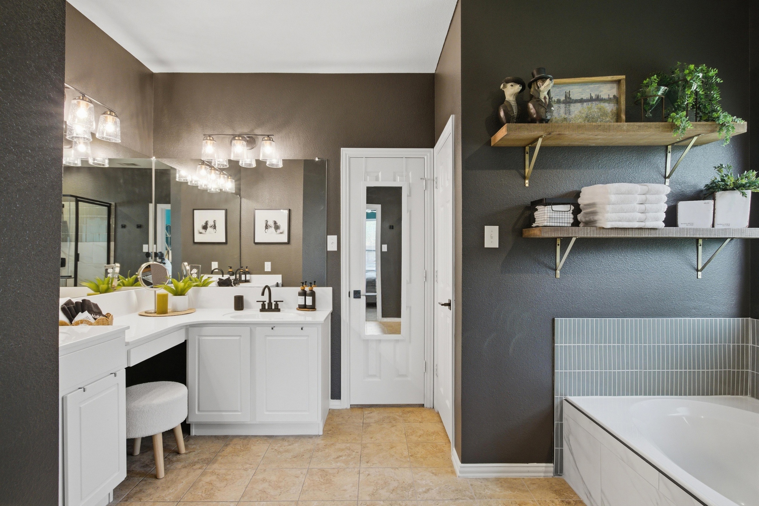 Master Bathroom Vanity area with deep storage, refined fixtures, and a dedicated seated makeup station. Stocked with essentials by Ginger Lily Farms.
