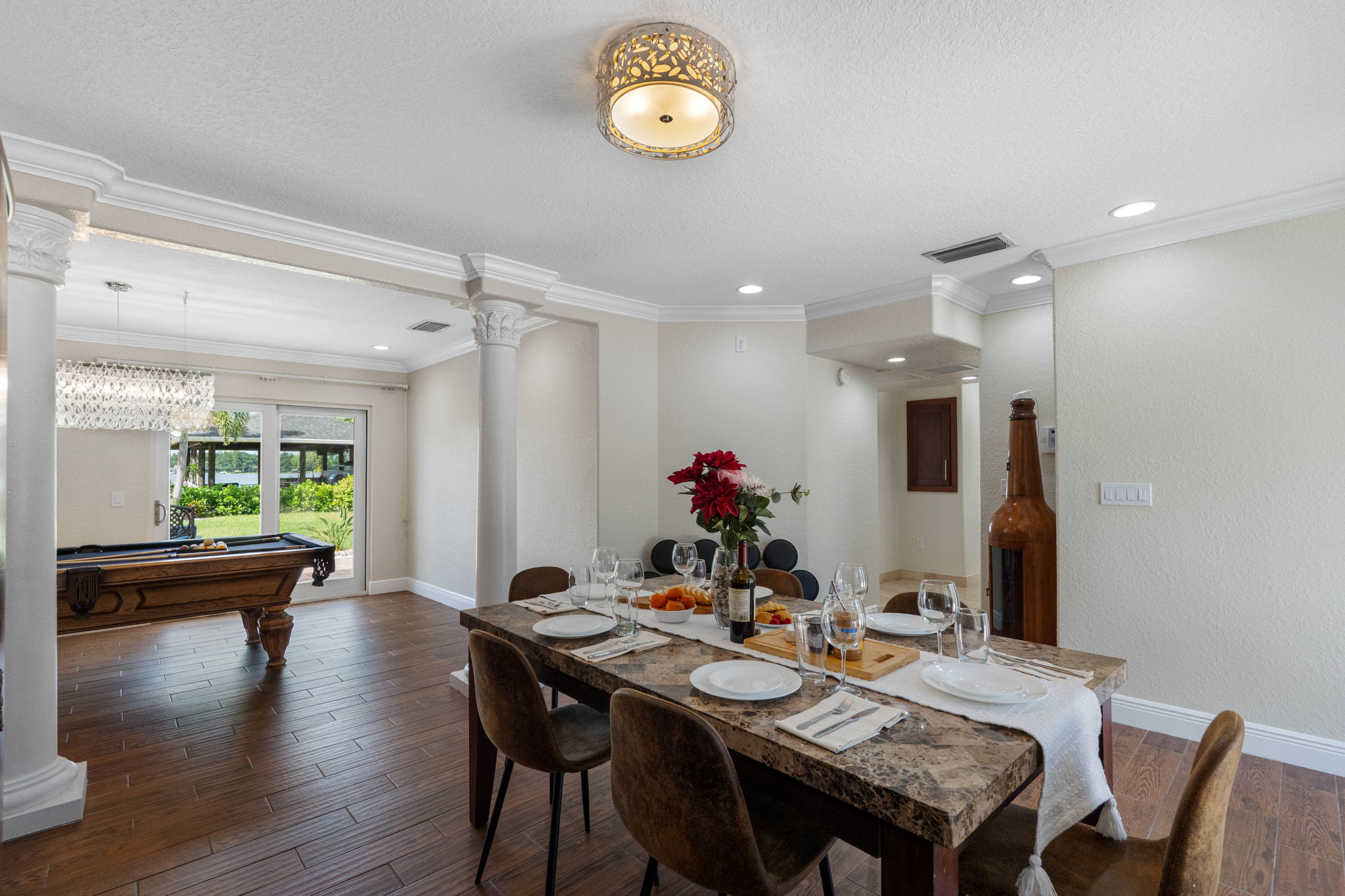 The dining space flows seamlessly into the game and kitchen areas, making it perfect for hosting large gatherings and dinner parties.