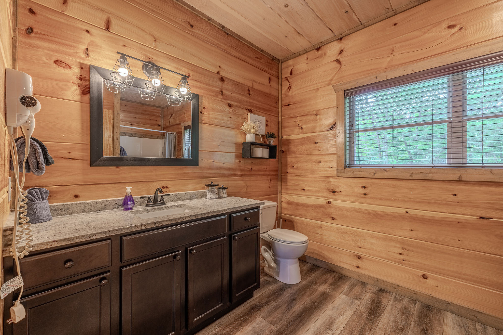 The Cartographer’s Suite ensuite bathroom offers private convenience for the main-level king bedroom.