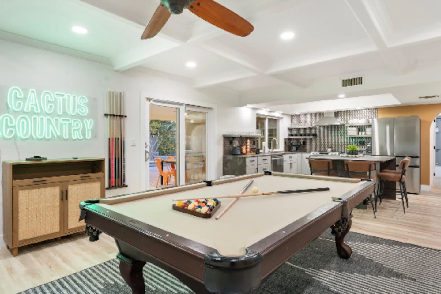 The "Cactus Country" neon sign gives this game room its own personality, with a well-stocked kitchen never far from the action.