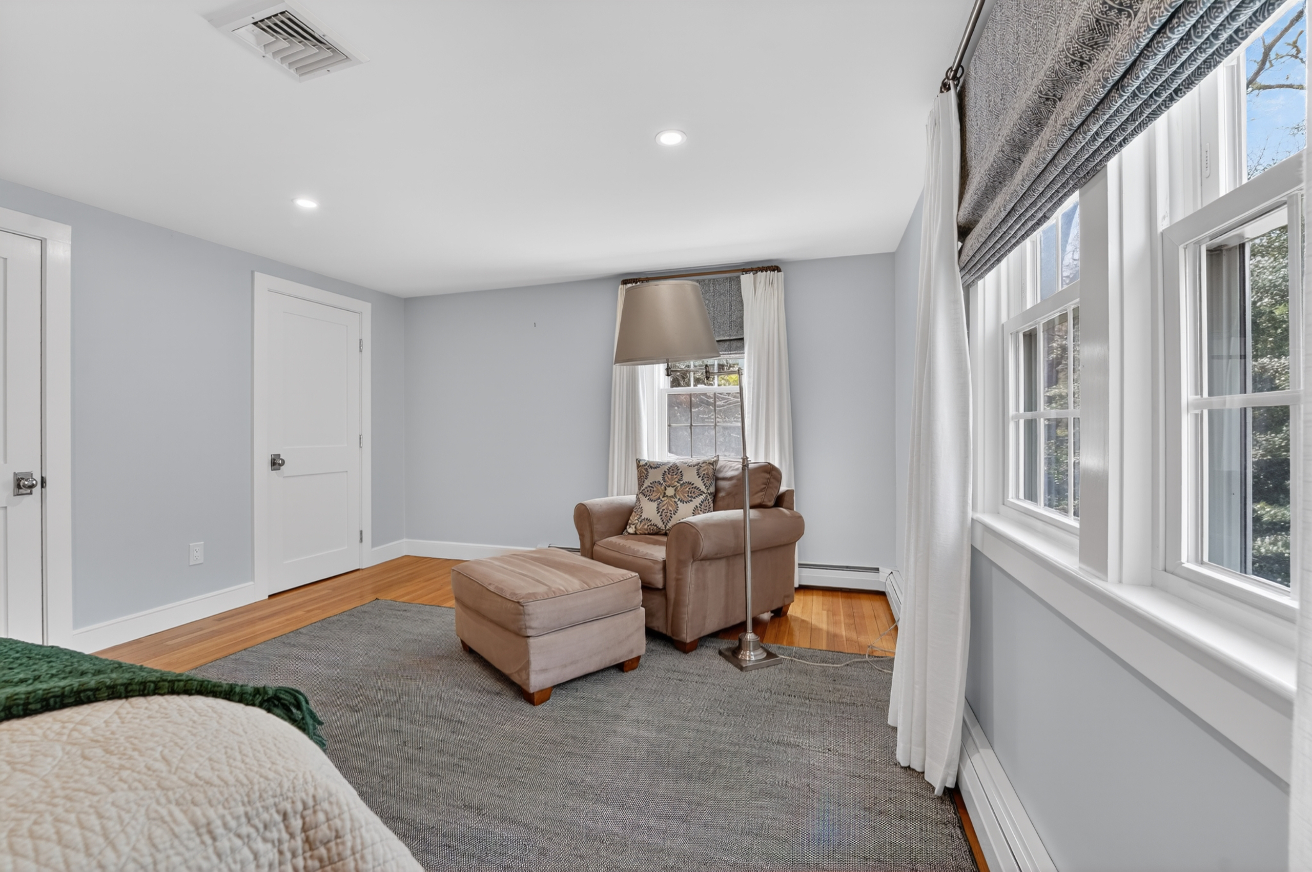 The third bedroom blends comfort and charm with a queen bed and a relaxing solo couch!