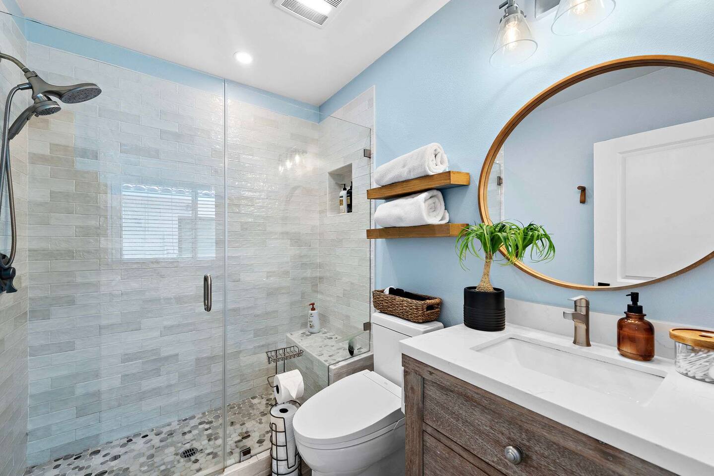 The newly remodeled bathroom is fully equipped with a beautiful tile shower, bidet, hairdryer, fluffy towels, soap, shampoo, and conditioner. The building also has a water softener so the shower feels luxurious. There are outdoor showers too!