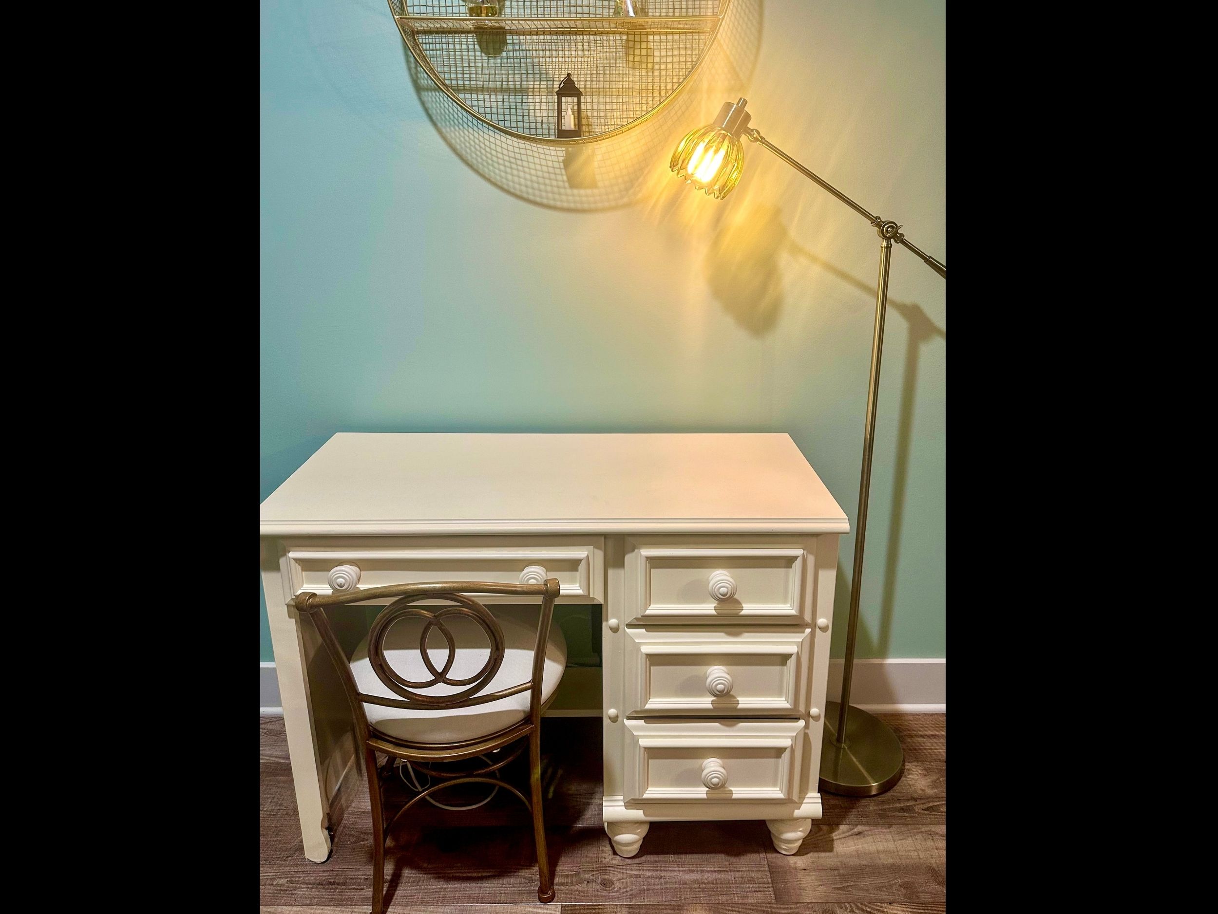 Living room workspace featuring a dedicated desk with task lamp, offering a comfortable spot for remote work or personal projects.