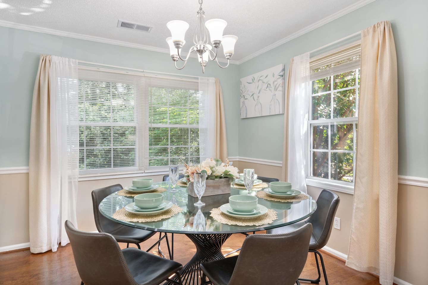 This elegant six-seat dining area offers beautiful natural light, garden views, and a perfect place for shared meals.