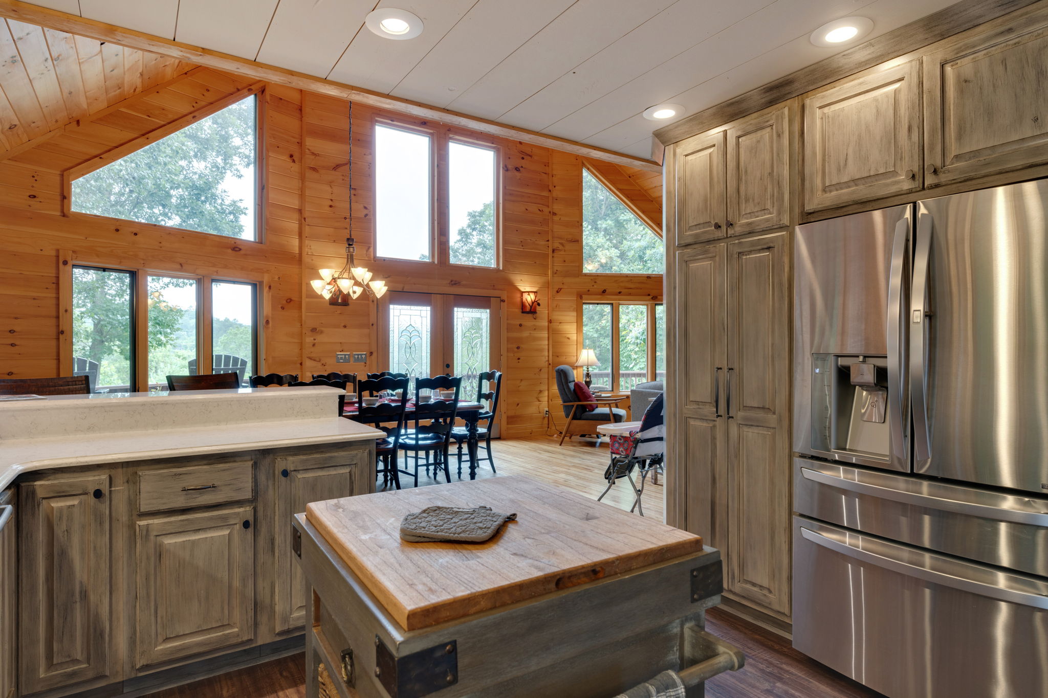 View of living room, dining room and windows with view of mountains from the kitchen.
