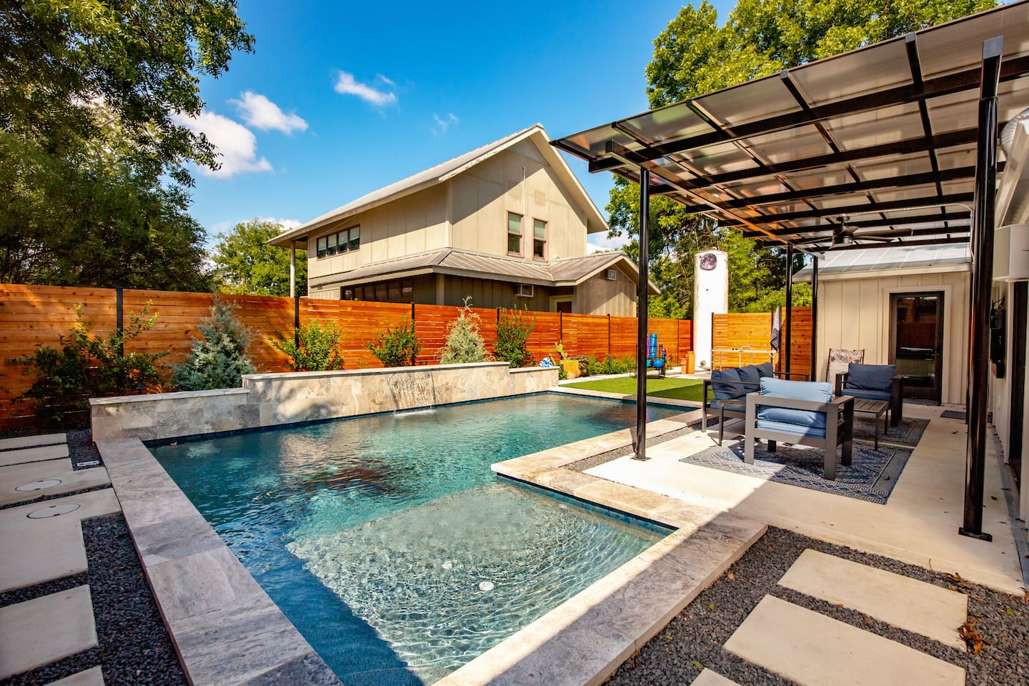 Spacious heated pool and green turf perfect for a morning dip or lounging in the San Antonio sun.