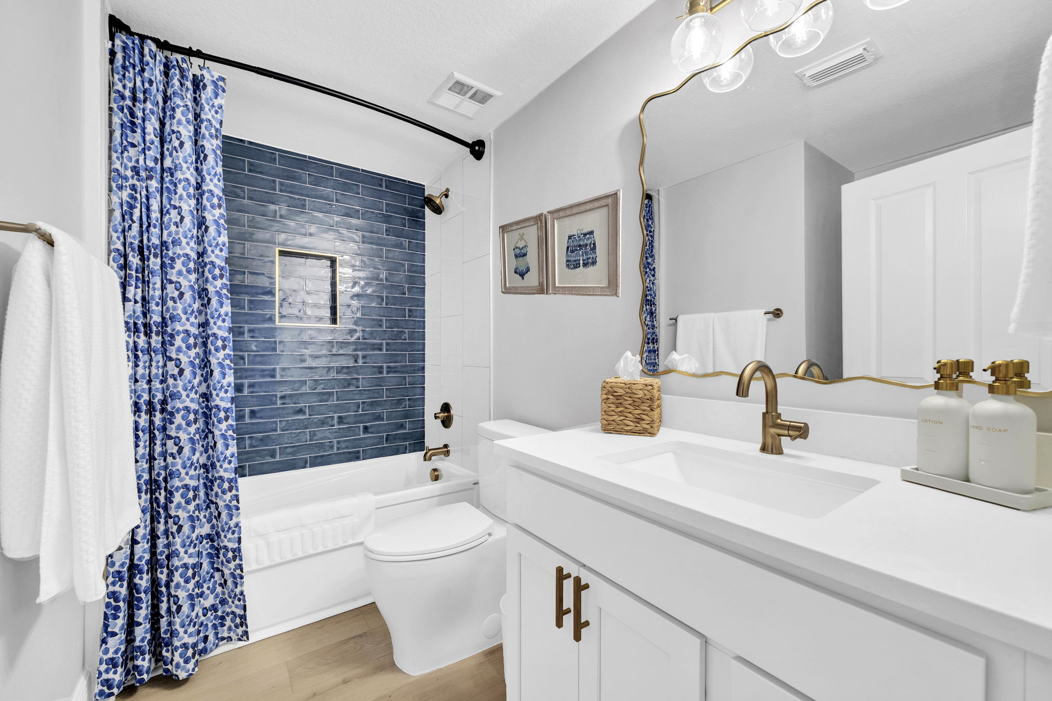 The second king bedroom offers a private en suite bath with additional hallway access, complete with a deep soaking tub/shower combo and comfort-height toilet.