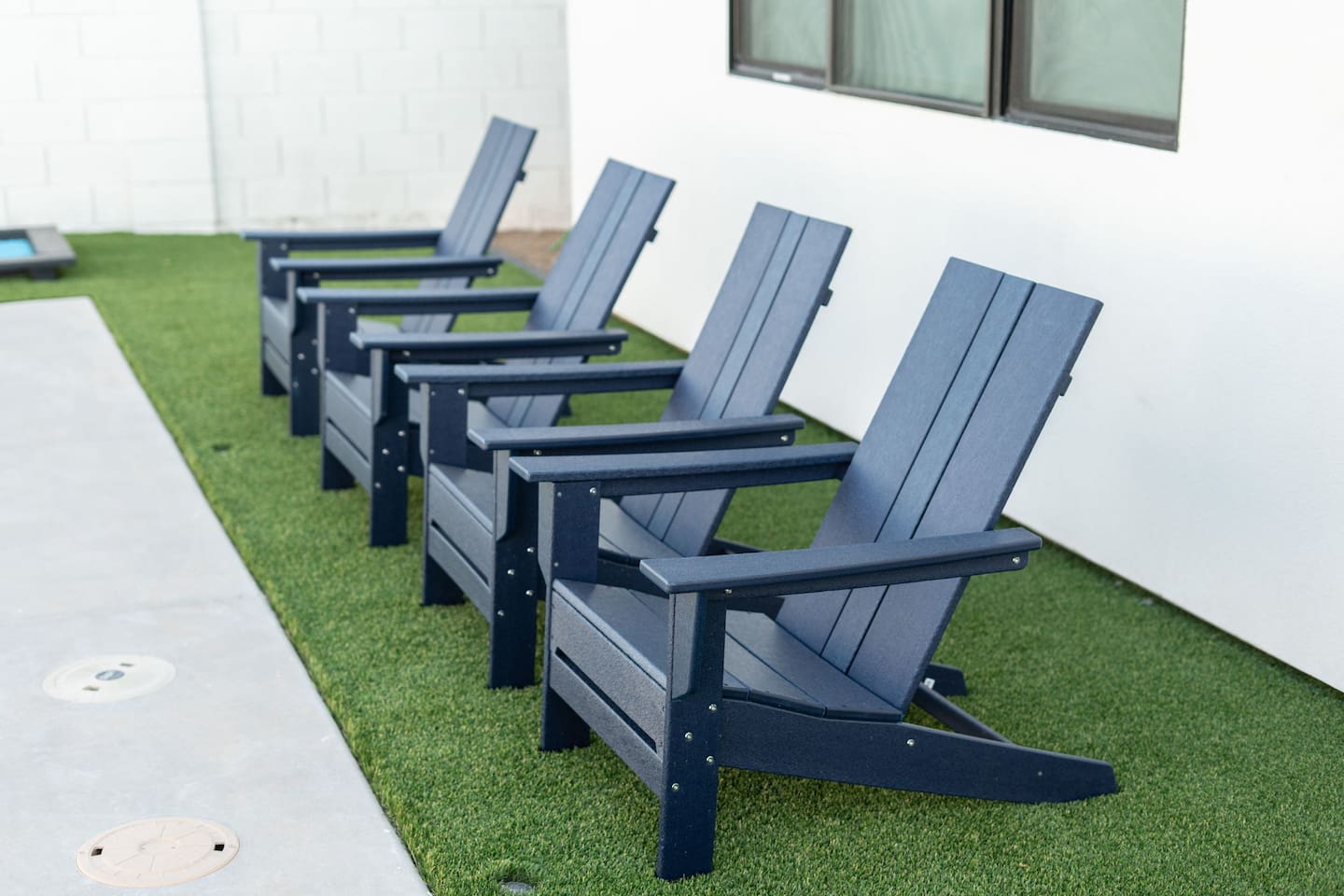 A row of modern navy chairs offers a relaxing spot to sit back and enjoy the outdoors.