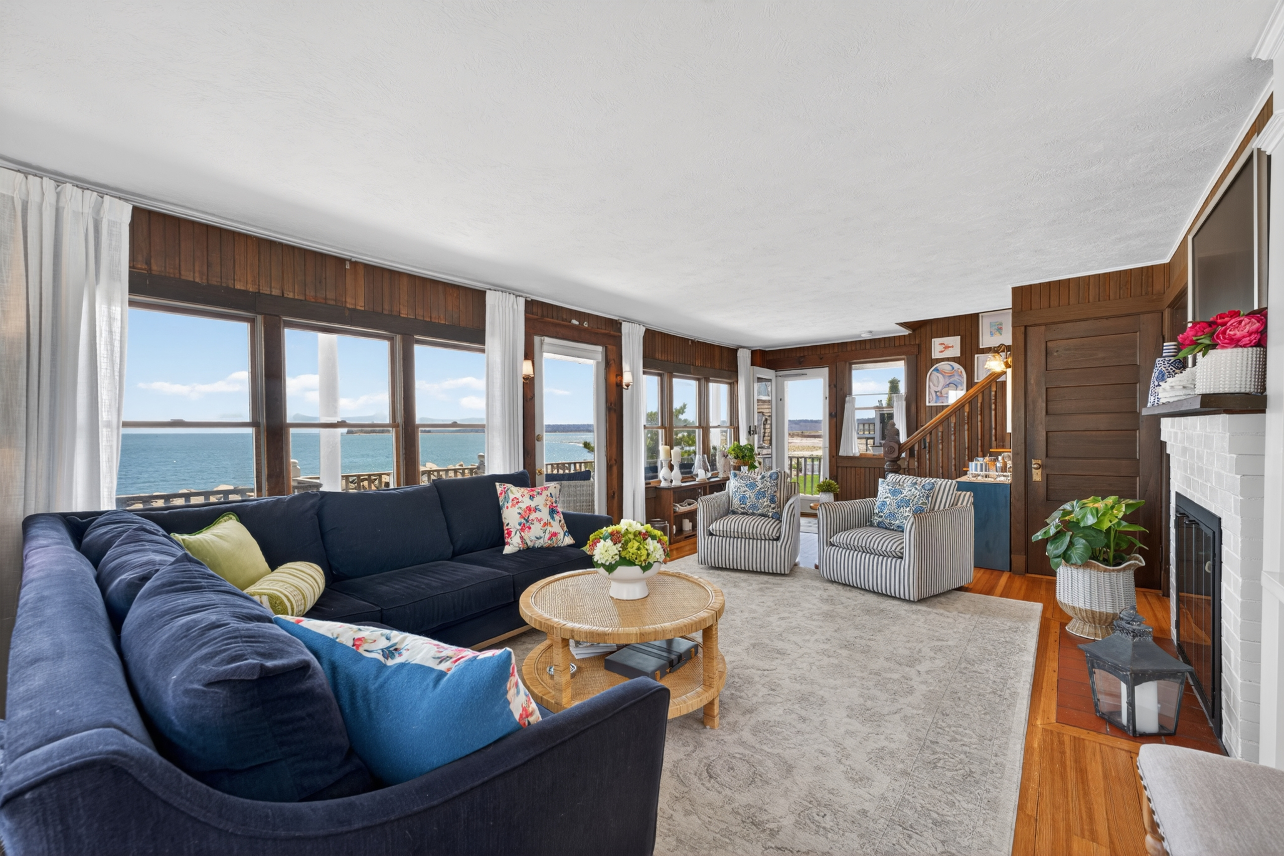 Relax in a bright, cozy living room with beautiful ocean views and coastal charm. 🌊