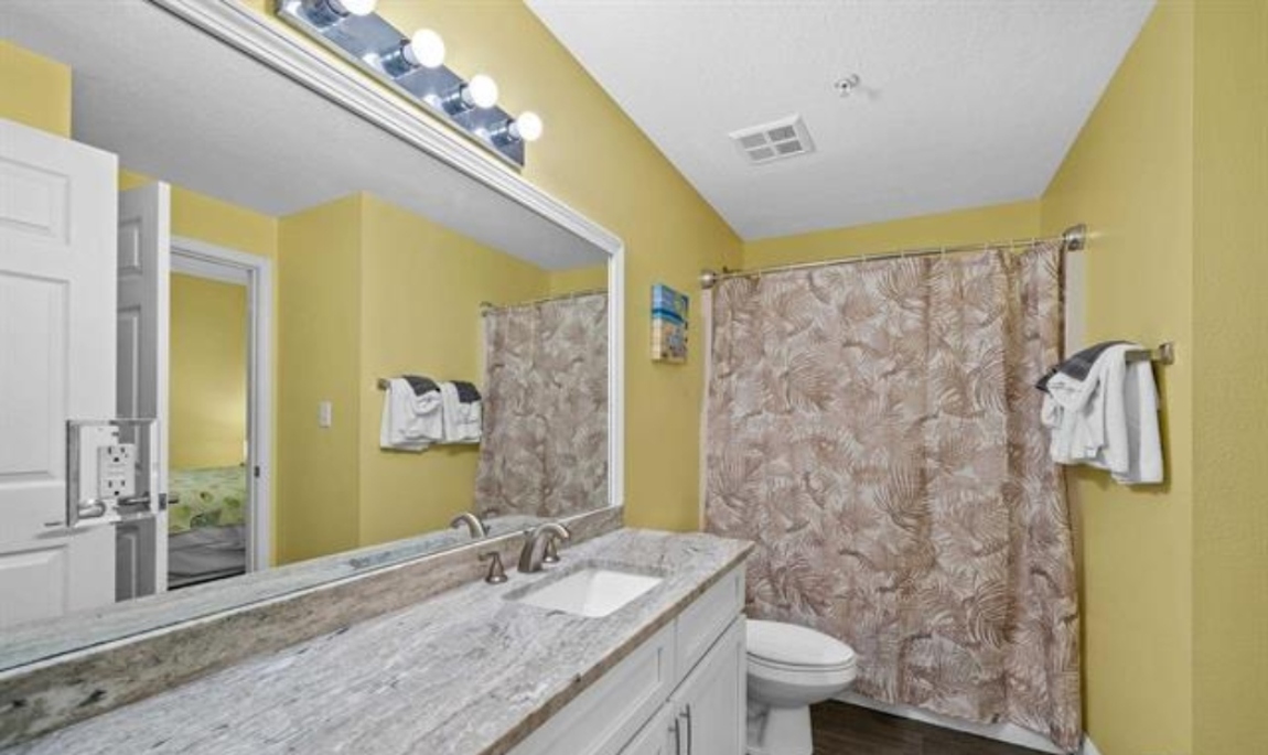 2nd bathroom with vanity, tub/shower combo and a door to the main area and a separate door to the 2nd bedroom