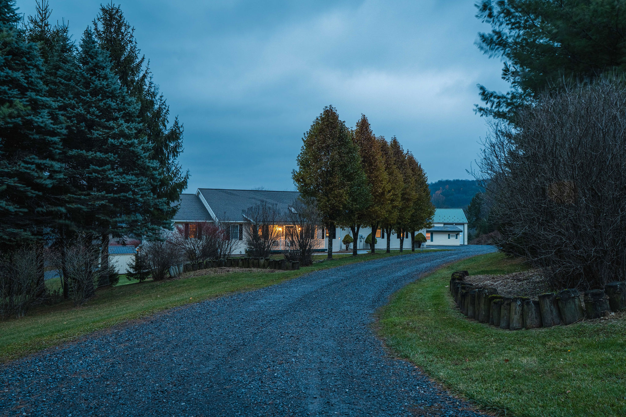 Peaceful private driveway leading to the home at dusk
