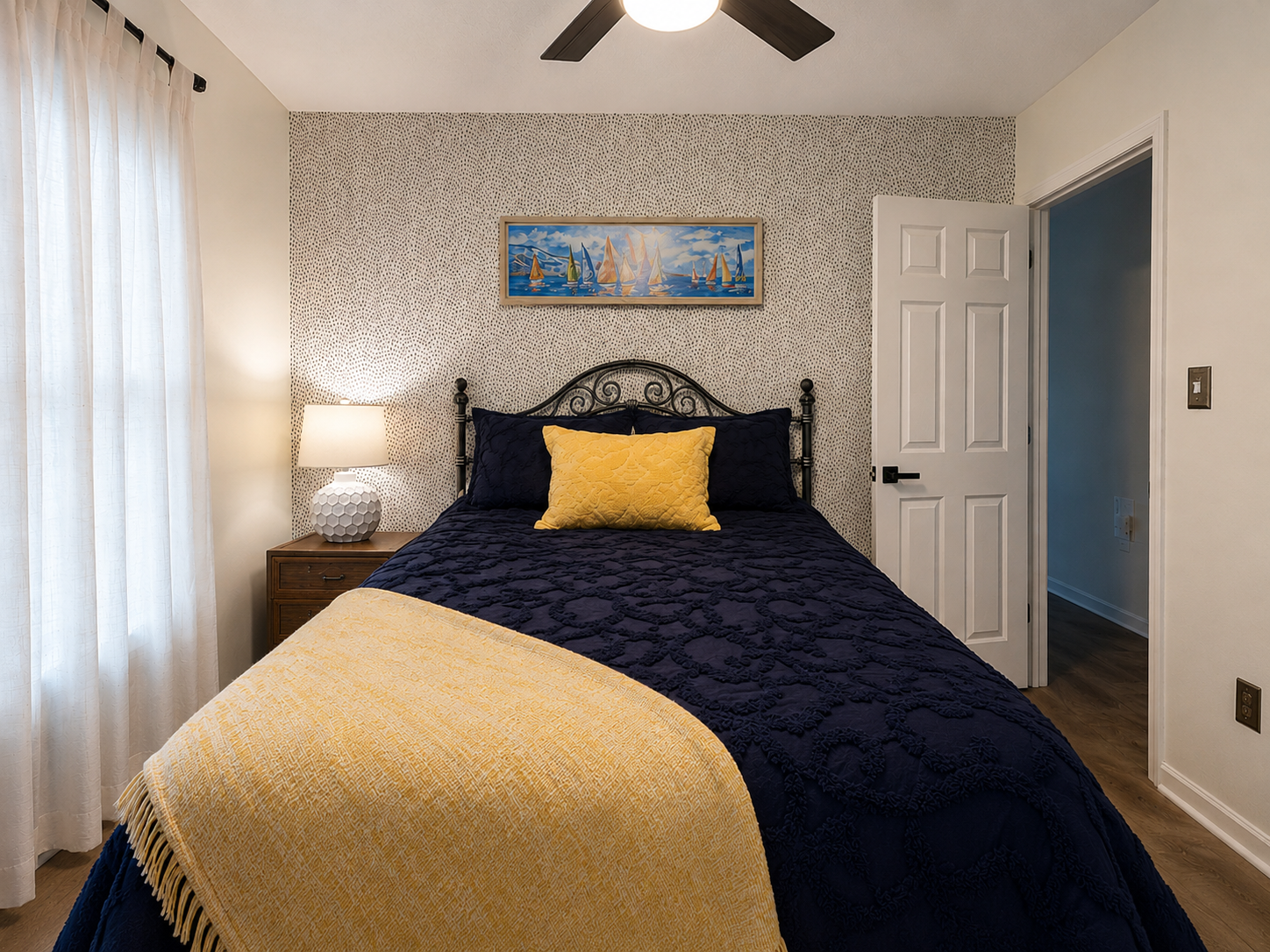 Comfortable queen bedroom on the main level with bedside lighting, closet access and a calm, restful feel.