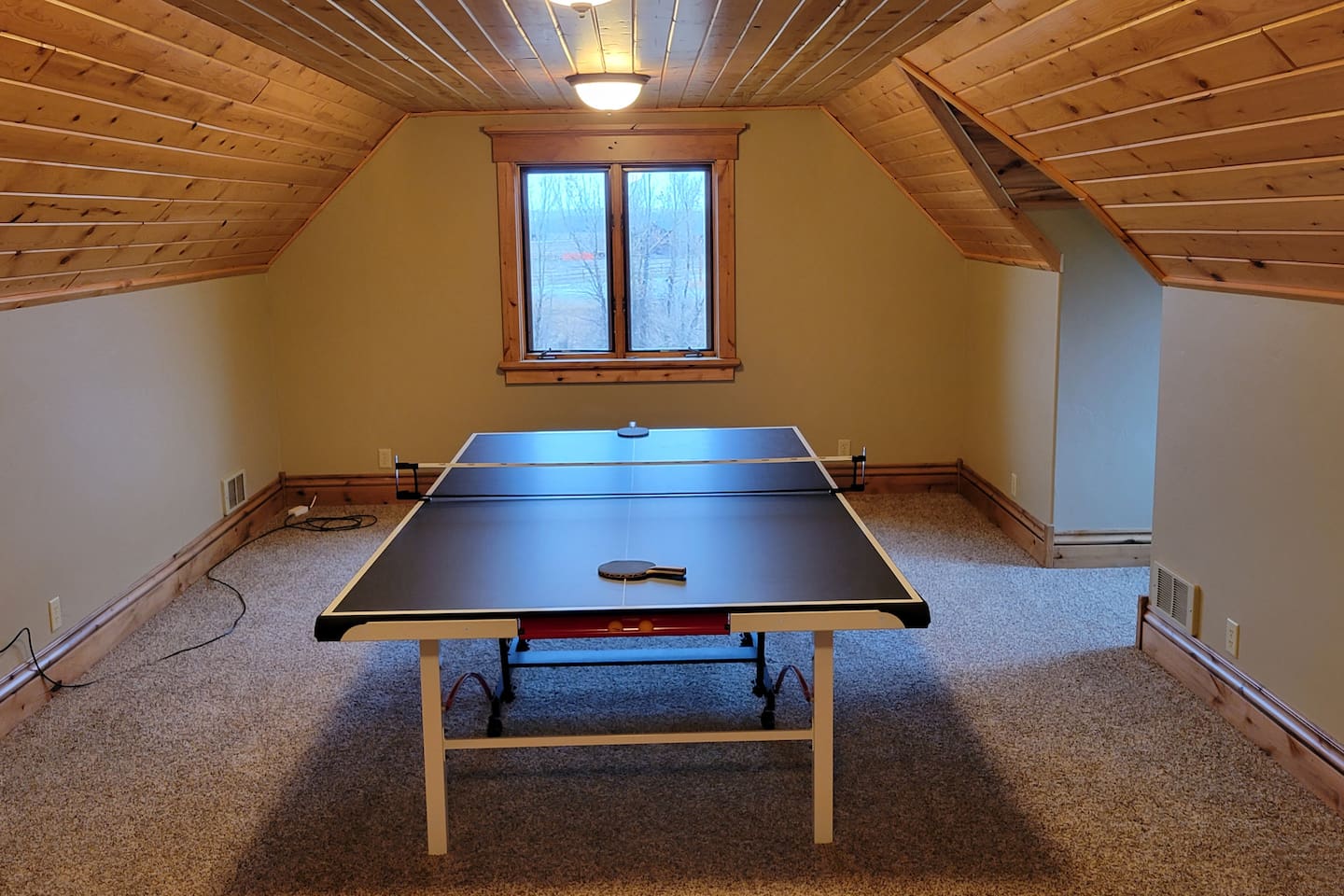 Ping pong table in the bonus room over garage.