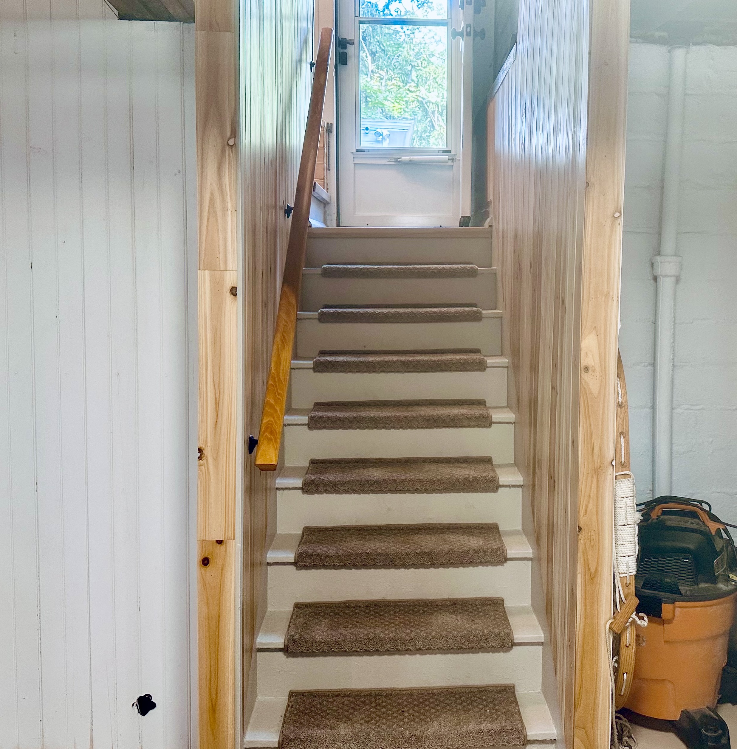 Stairs & handrail leading from the backporch/mudroom area to the basement.