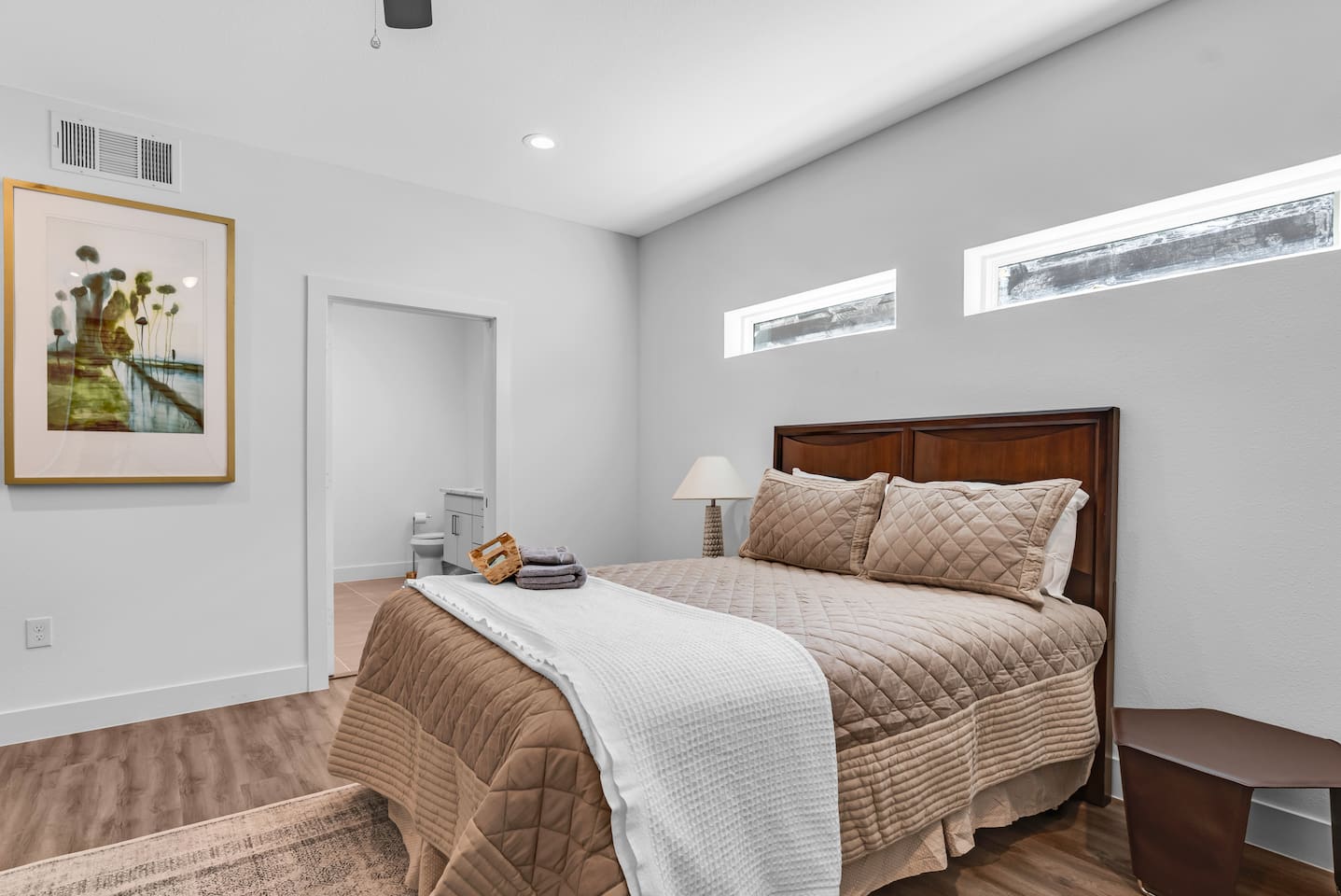 Unwind in the cozy primary bedroom with ensuite bath, luxury linens, and smart TV.