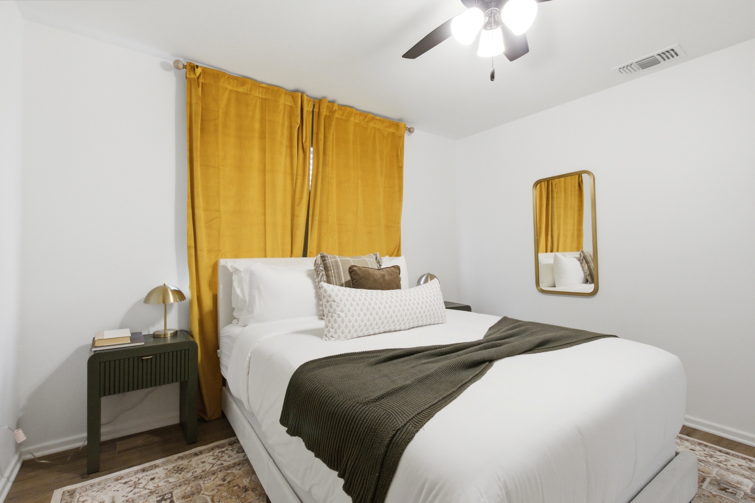 Queen Bed in Bedroom 3 with full-length mirror, soft bedding, and warm light. Quiet, restful nights in this Arlington neighborhood.
