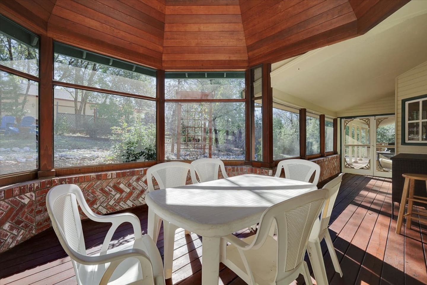 Sunroom with table seating, bar counter, and a peaceful spot to enjoy the view.
