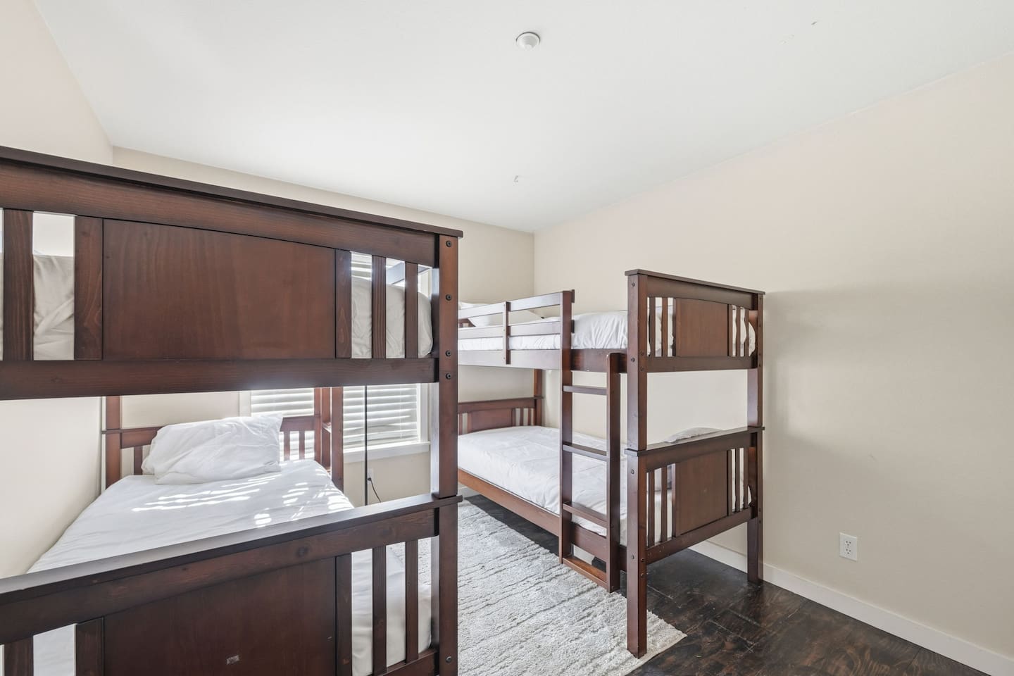 Bunk room with two sets of twin bunk beds, sleeps 4. Room-darkening shades, bed linens, and extra pillows and blankets provided. Ideal for kids and large family groups.