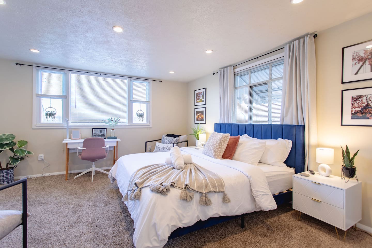 Cozy, spacious room with a queen-sized bed, TV, and a dedicated working space.