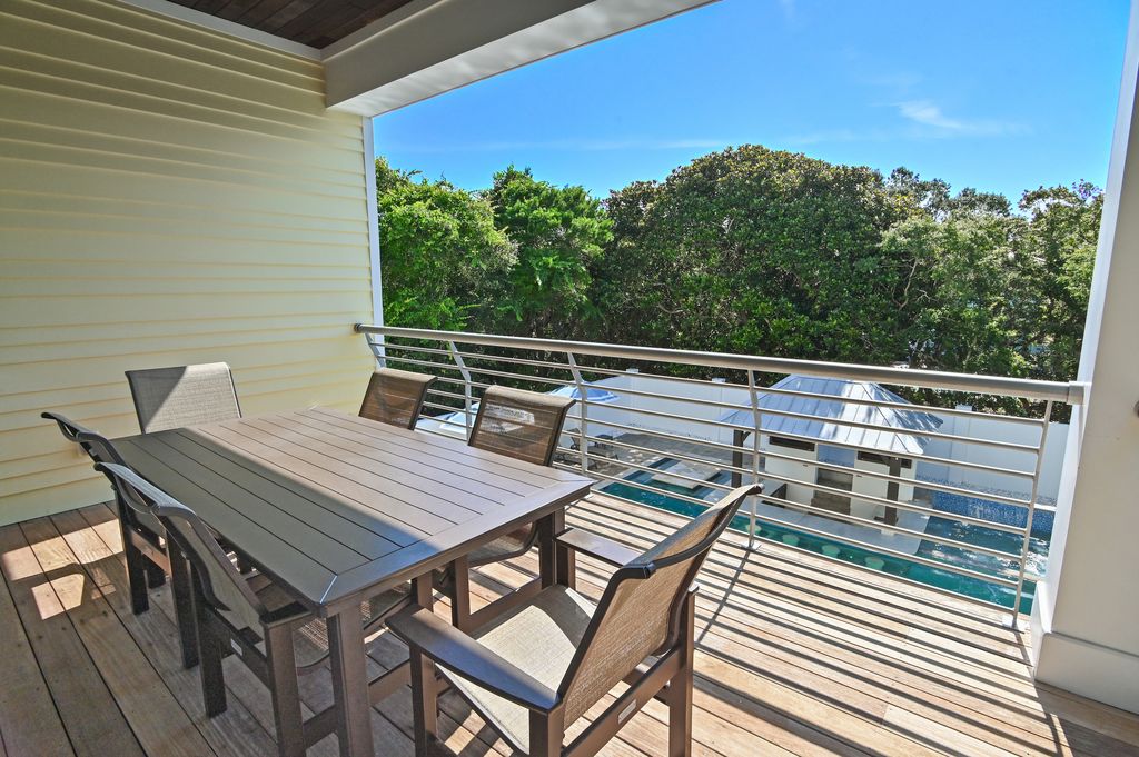 Pool-view balcony with seating for six