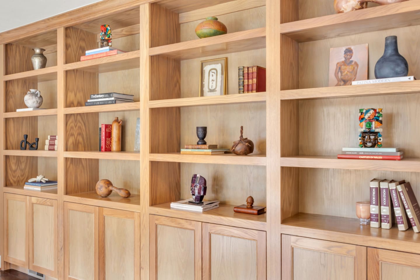Decorative bookshelf styled with elegant artifacts and curated accents, adding a refined, design-forward touch to the living space.