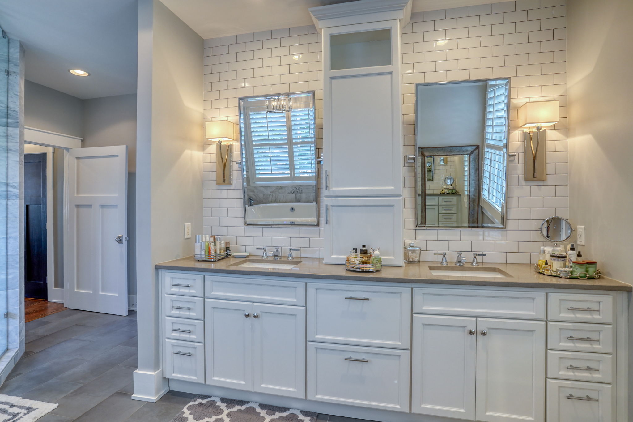 Spa-style primary bath with heated floor and dual vanities