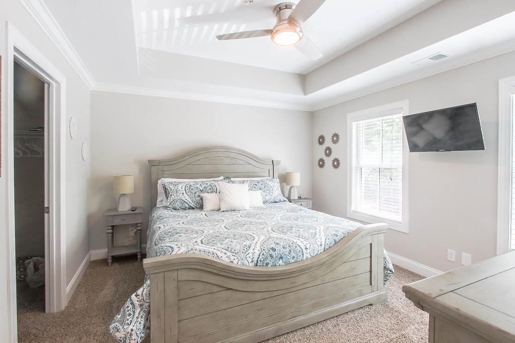 Bedroom 1 with king bed and mounted tv