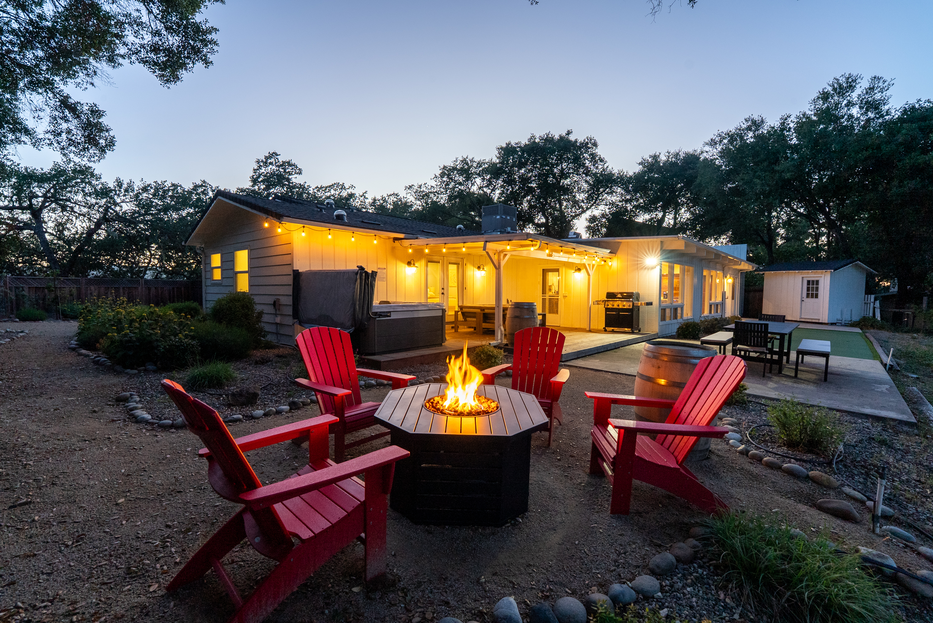 Gather around the fire for a cozy evening under a sky full of color.