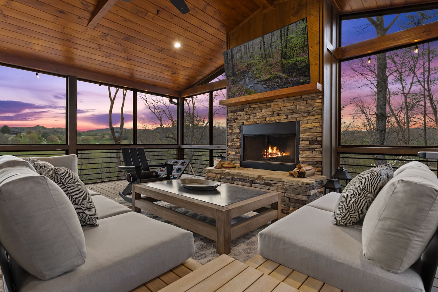 Fully screened in Party Deck features a 75" TV, wood burning fire pit, life-size games, ample seating, Weber grill and a breathtaking view! Watch the sunset and unwind bug-free!