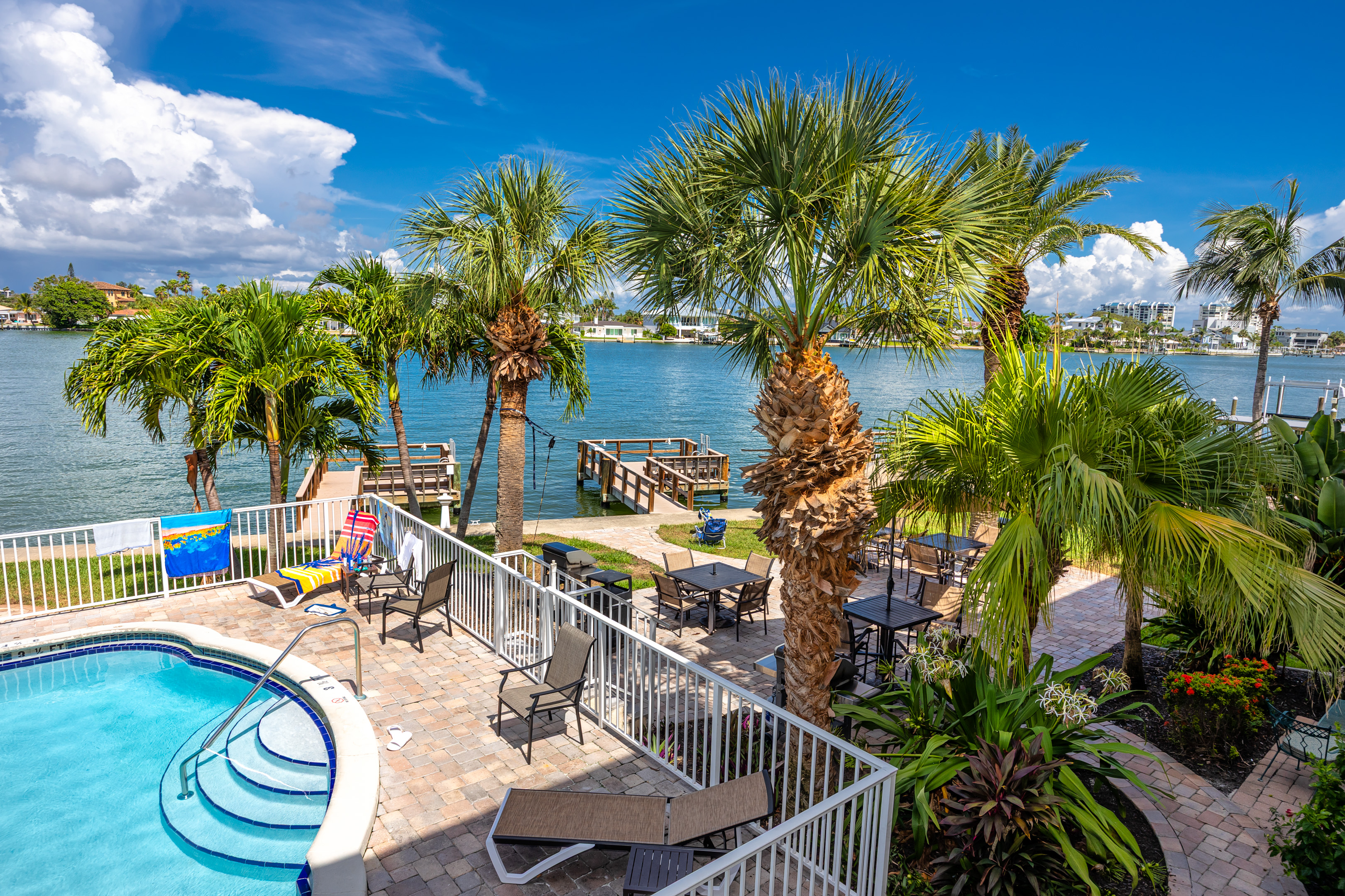 Beautiful waterfront pool area with patio for large groups