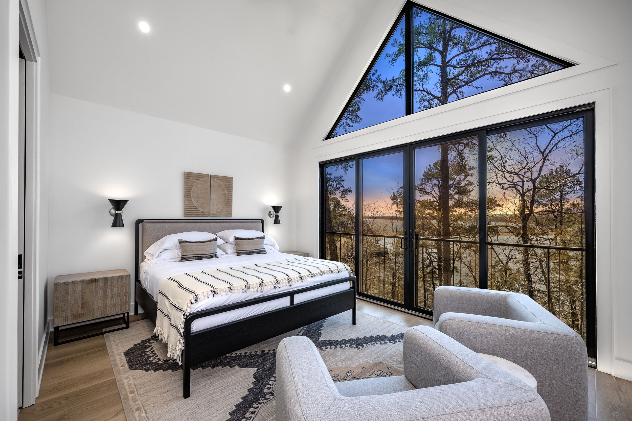 Vaulted ceilings, lake views, and designer touches make this king bedroom a guest favorite.