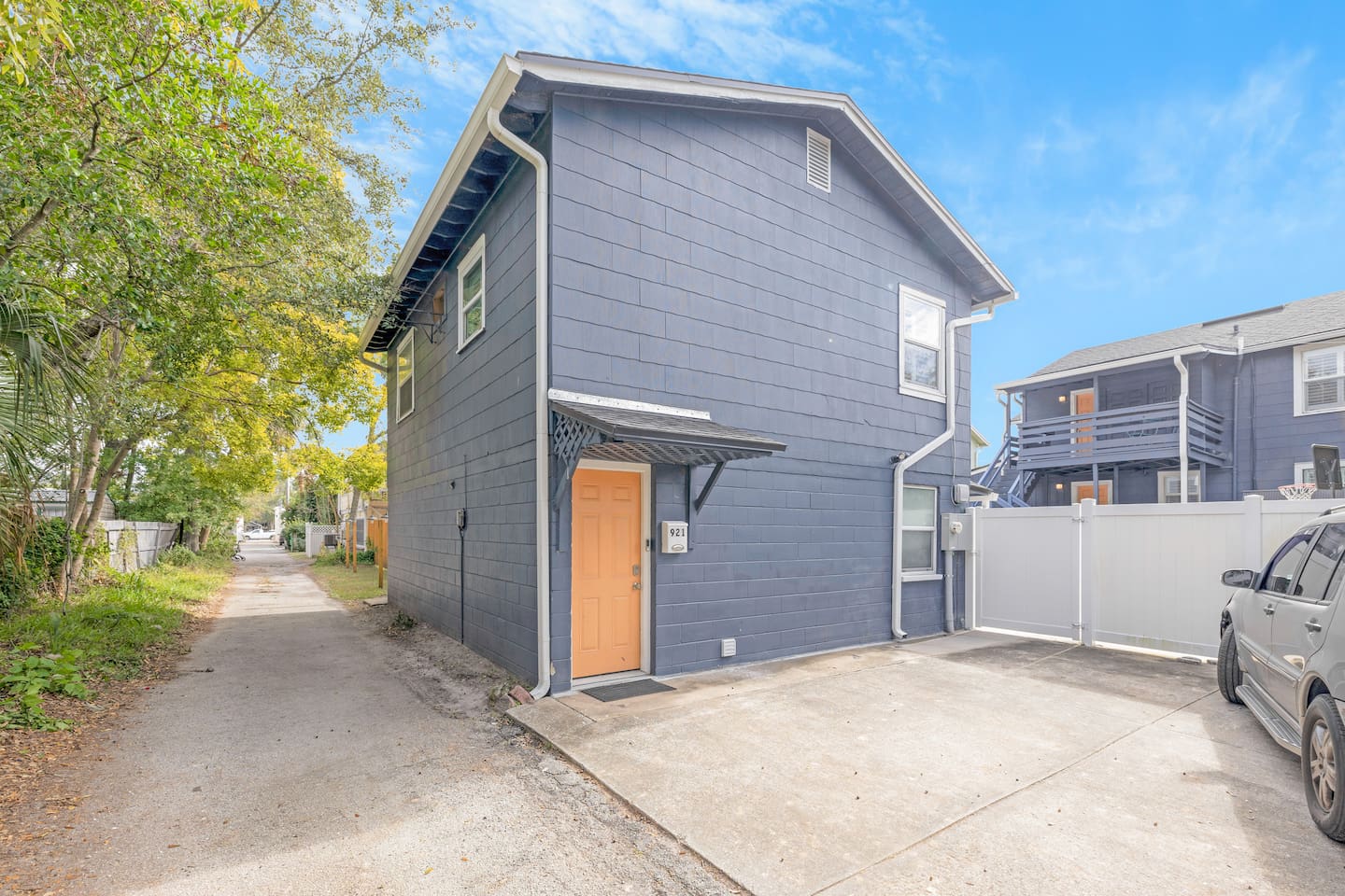 Home entrance in rear alleyway and parking area outside courtyard area