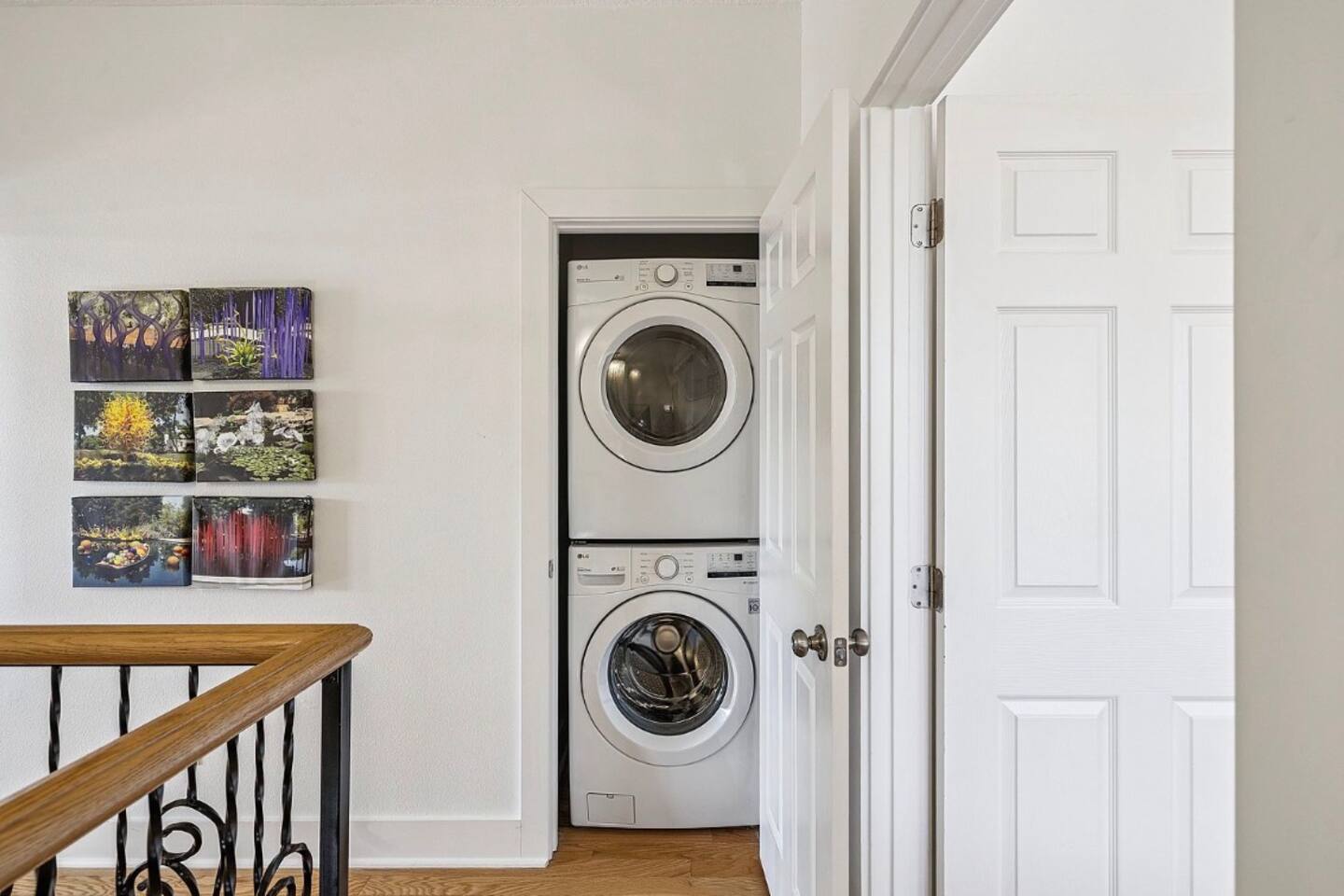 Convenient upstairs laundry closet featuring a stackable washer and dryer for easy clothes and beach towel care during your stay.