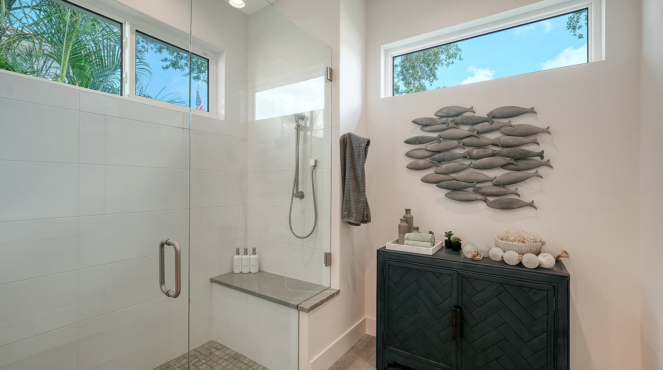 Spa-like shower experience with palm trees outside and aromatherapy spray