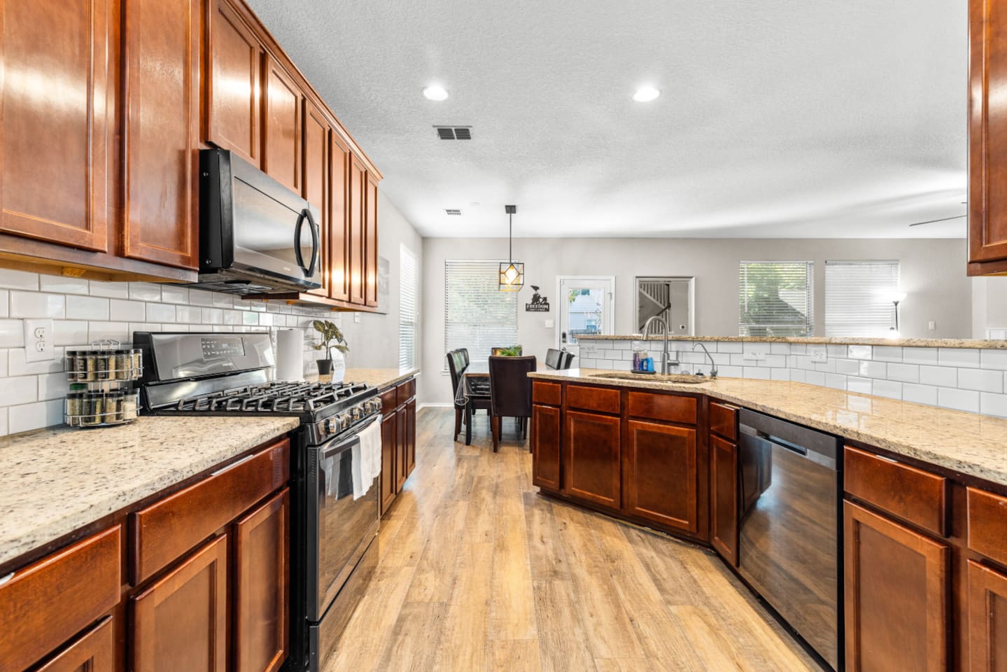 Family-ready full kitchen offering a dish washer, large fridge and freezer, stainless steel oven, microwave, dishwasher, and fully stocked essentials for cooking and dining in.