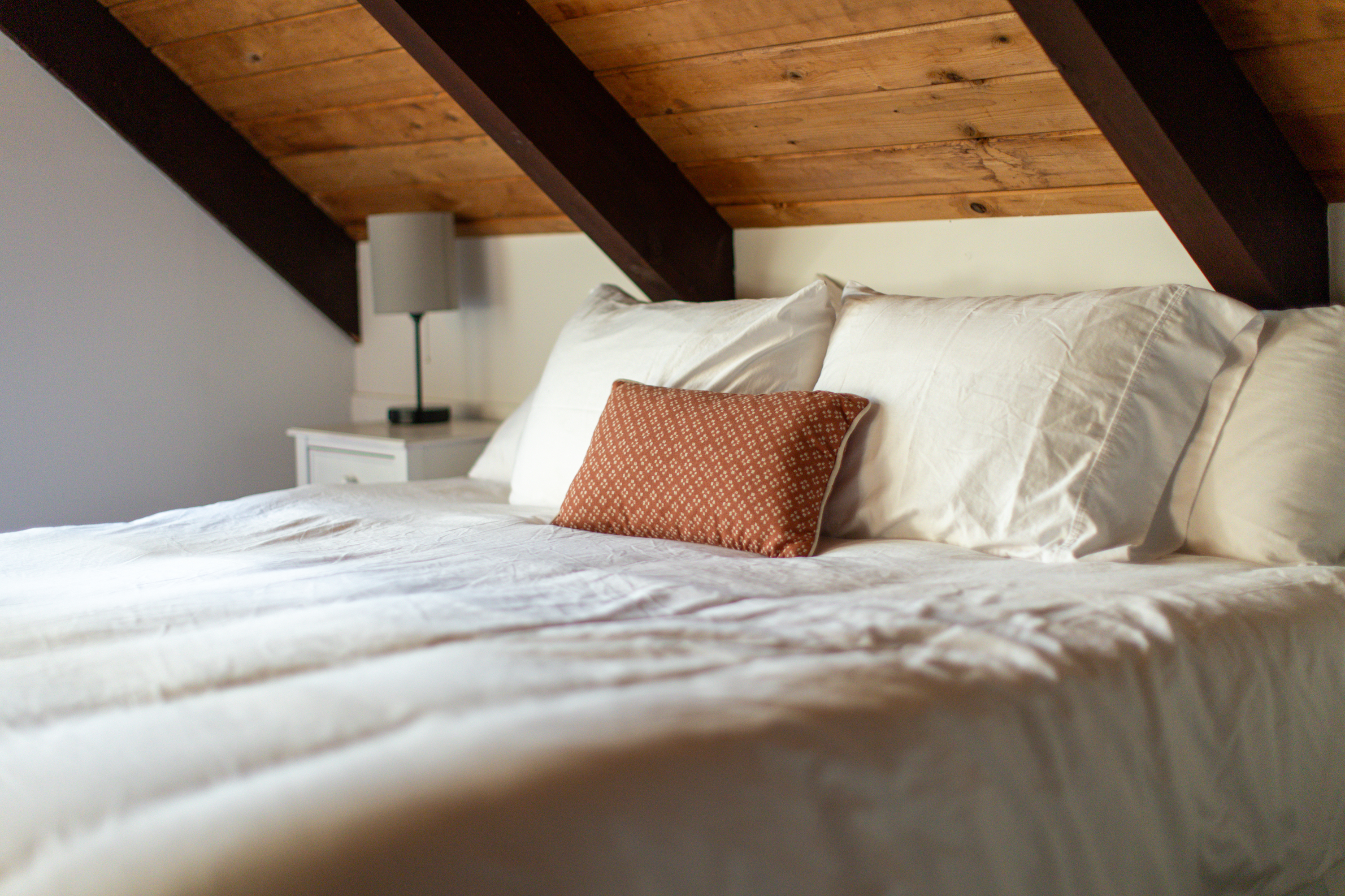 Loft Bedroom: Rustic charm meets comfort in this serene retreat with stunning wood beams. King size bed.