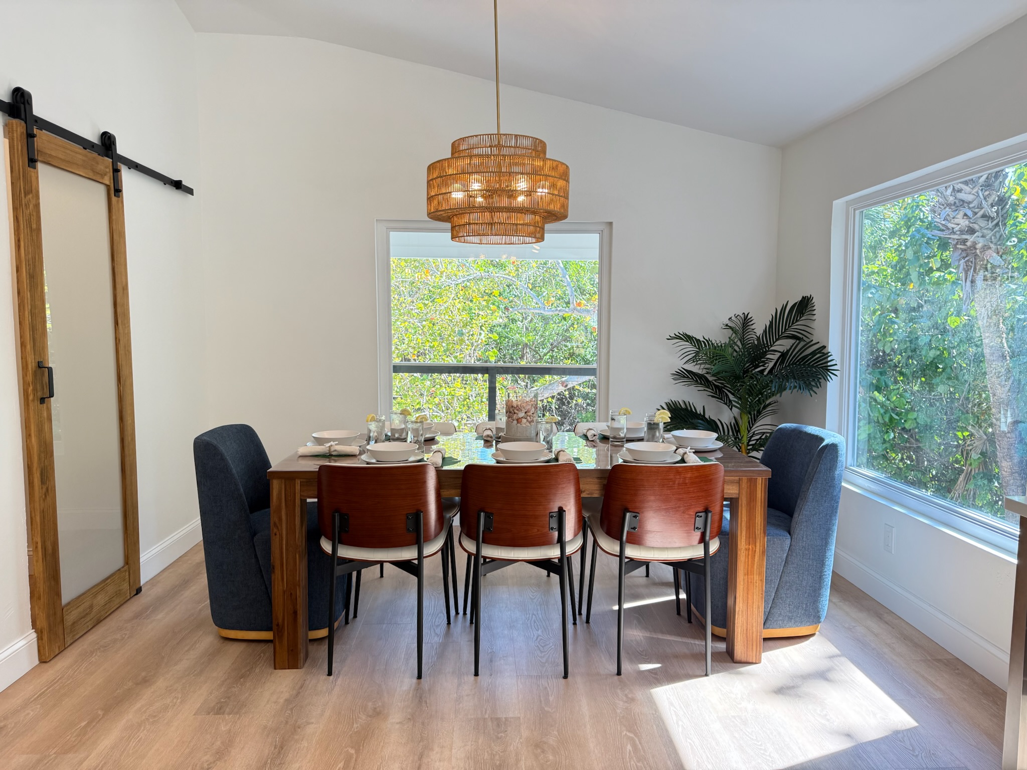 Comfortable dining surrounded by large windows and tropical views