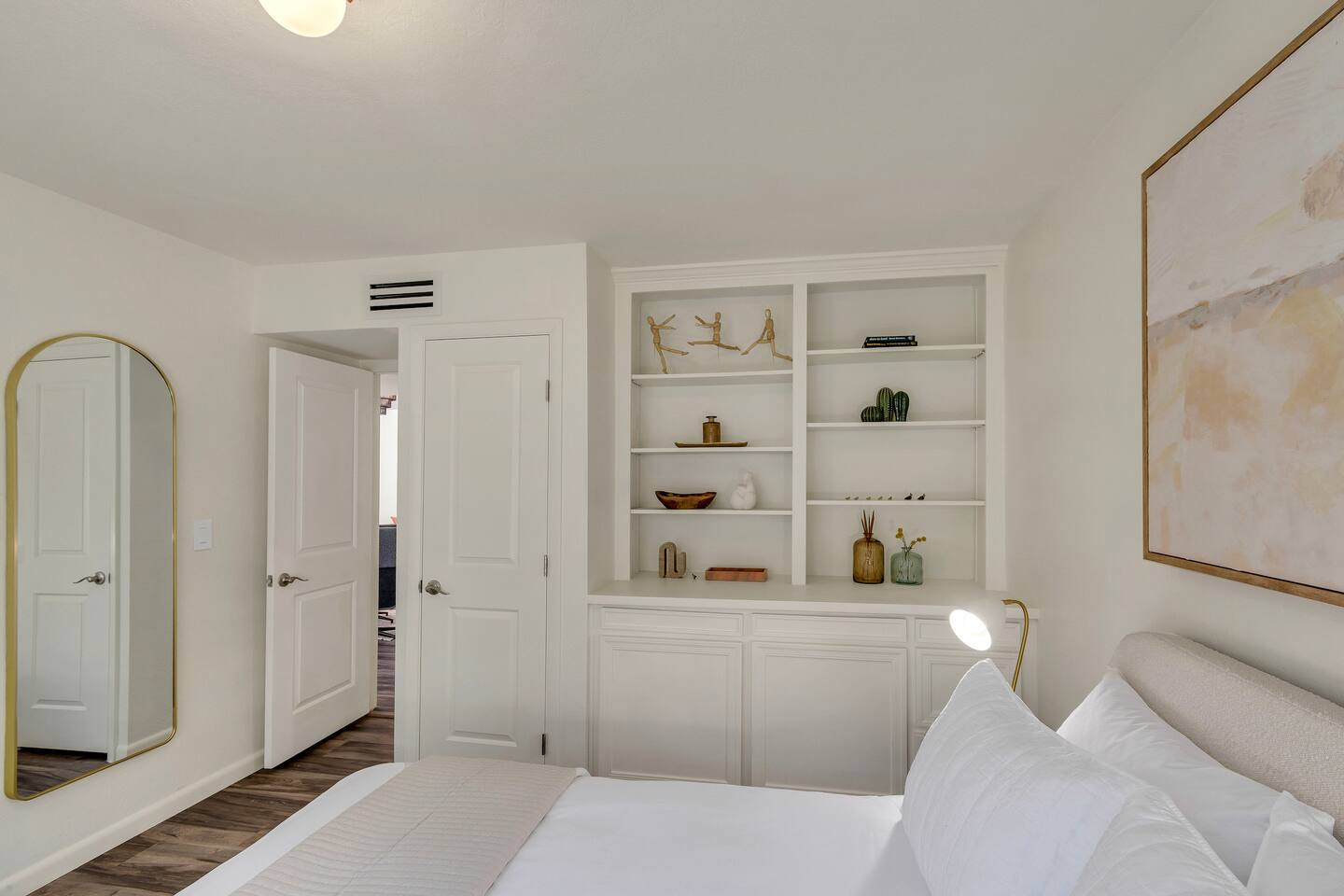 Queen bed, full mirror, and storage in the guest bedroom.