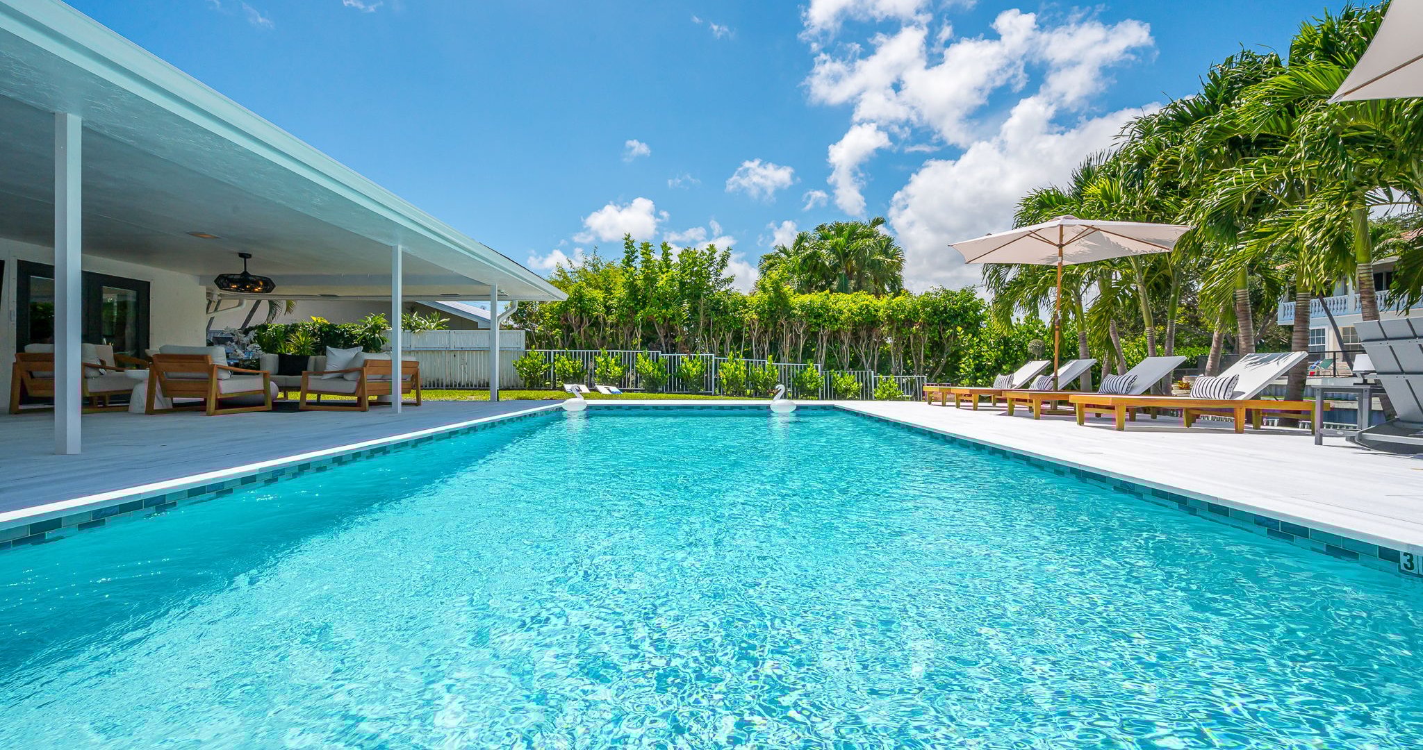 Spend your days lounging by the shimmering pool, dining al fresco under the covered patio, and unwinding in stylish outdoor living spaces—all set against a serene lakefront backdrop with private dock access