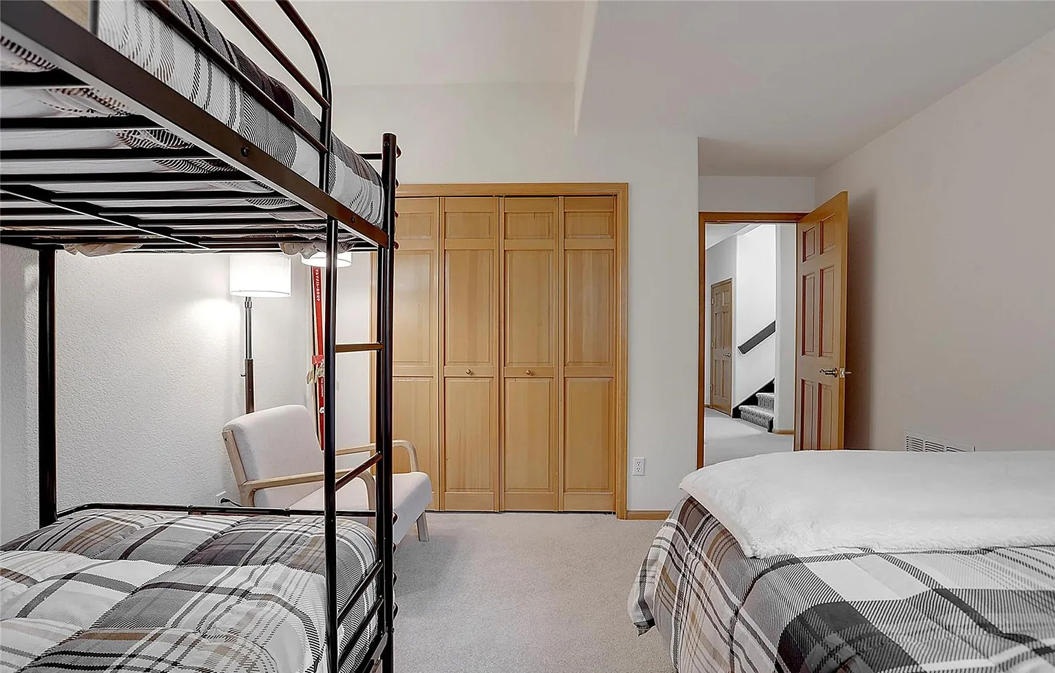 Perfect for families or groups, this versatile guest room features a comfortable double bed plus a twin-over-twin bunk bed setup.