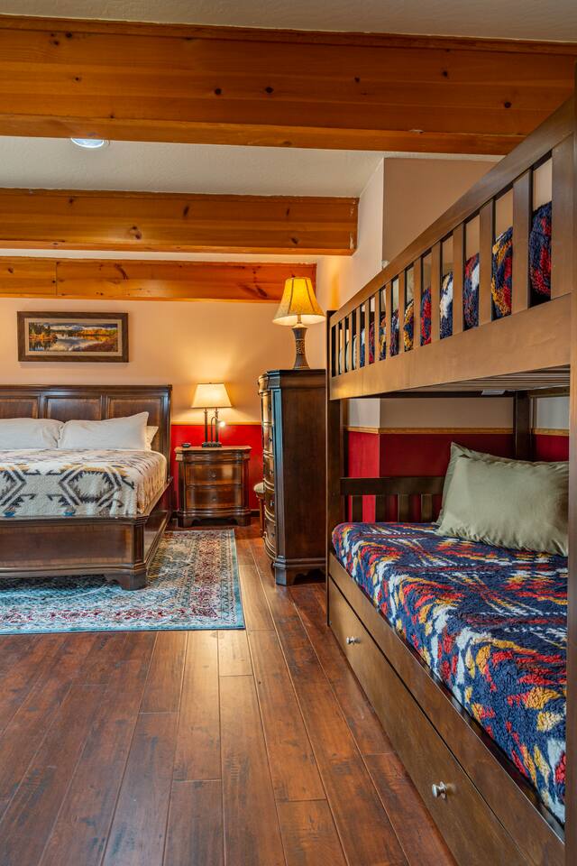 Down stairs bedroom with king size bed and twin over twin bunkbed