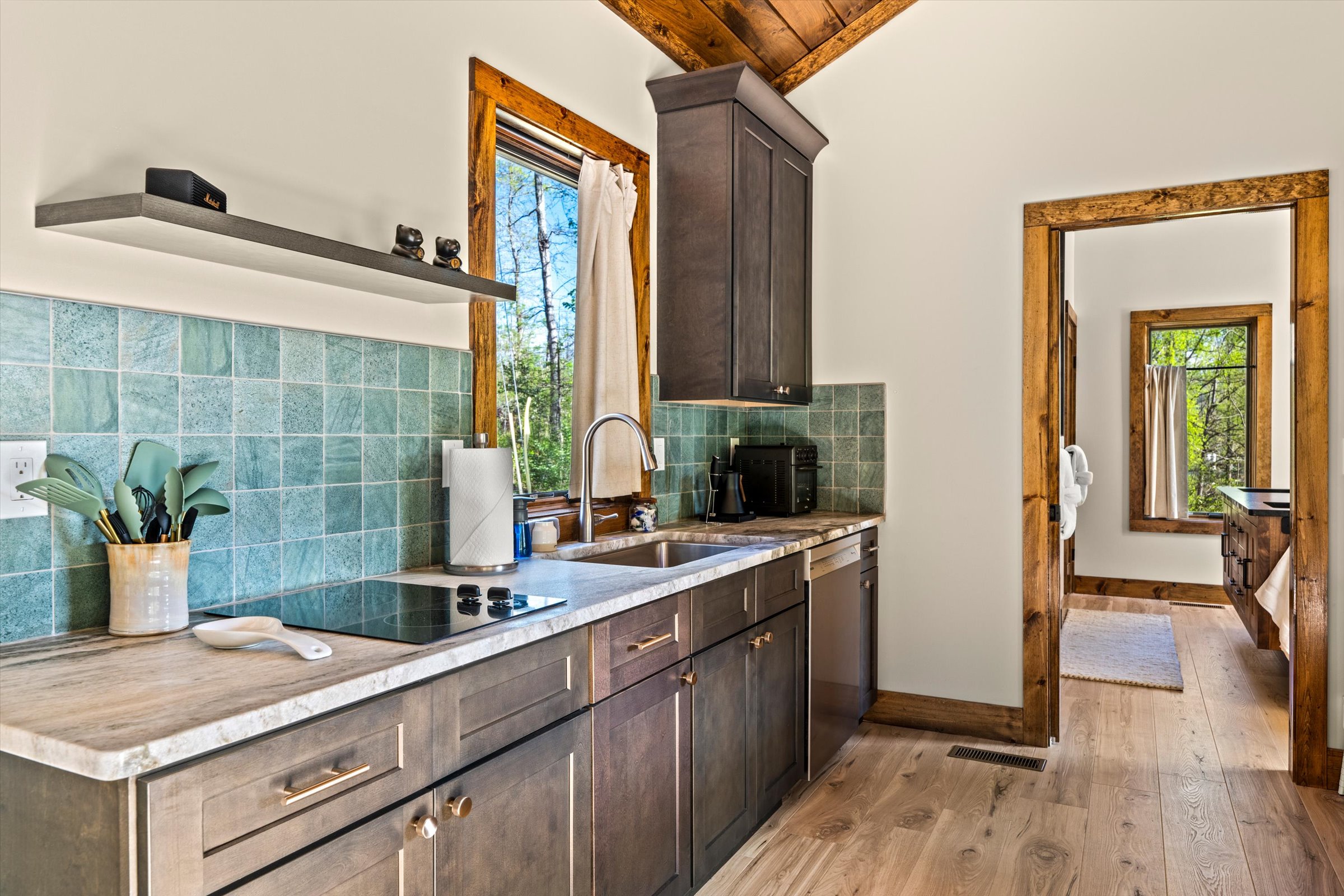 Kitchen with 2 burner cooktop and full-sized dishwasher with custom granite countertop