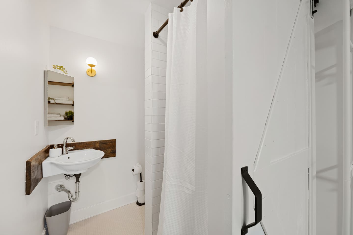 Full bathroom off of Primary bedroom features corner sink and tile shower with rain shower-head.