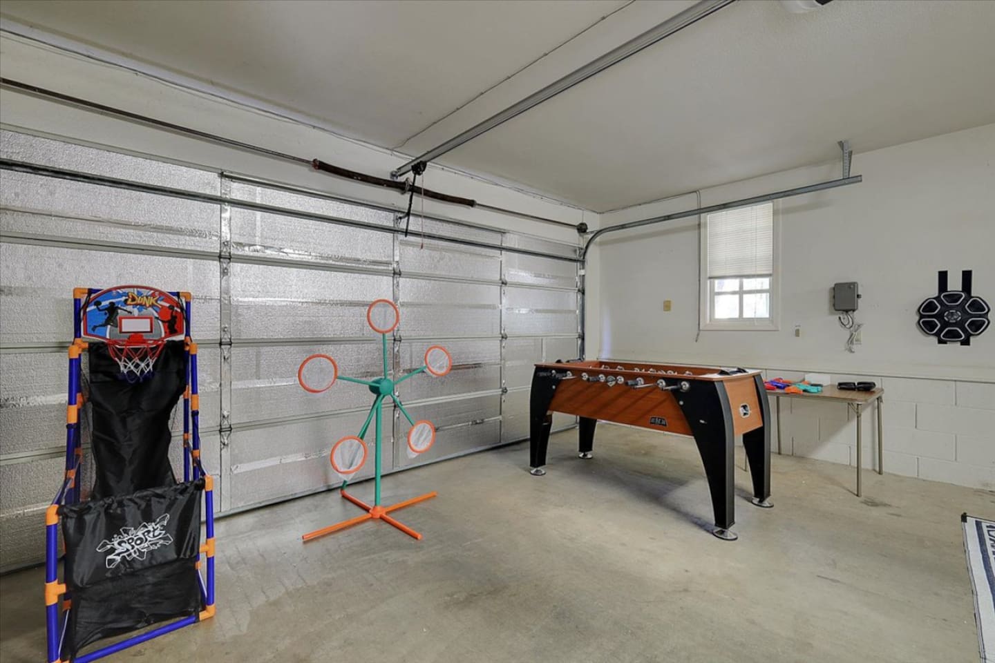 Game room with foosball, arcade games, and space for easy indoor fun.
